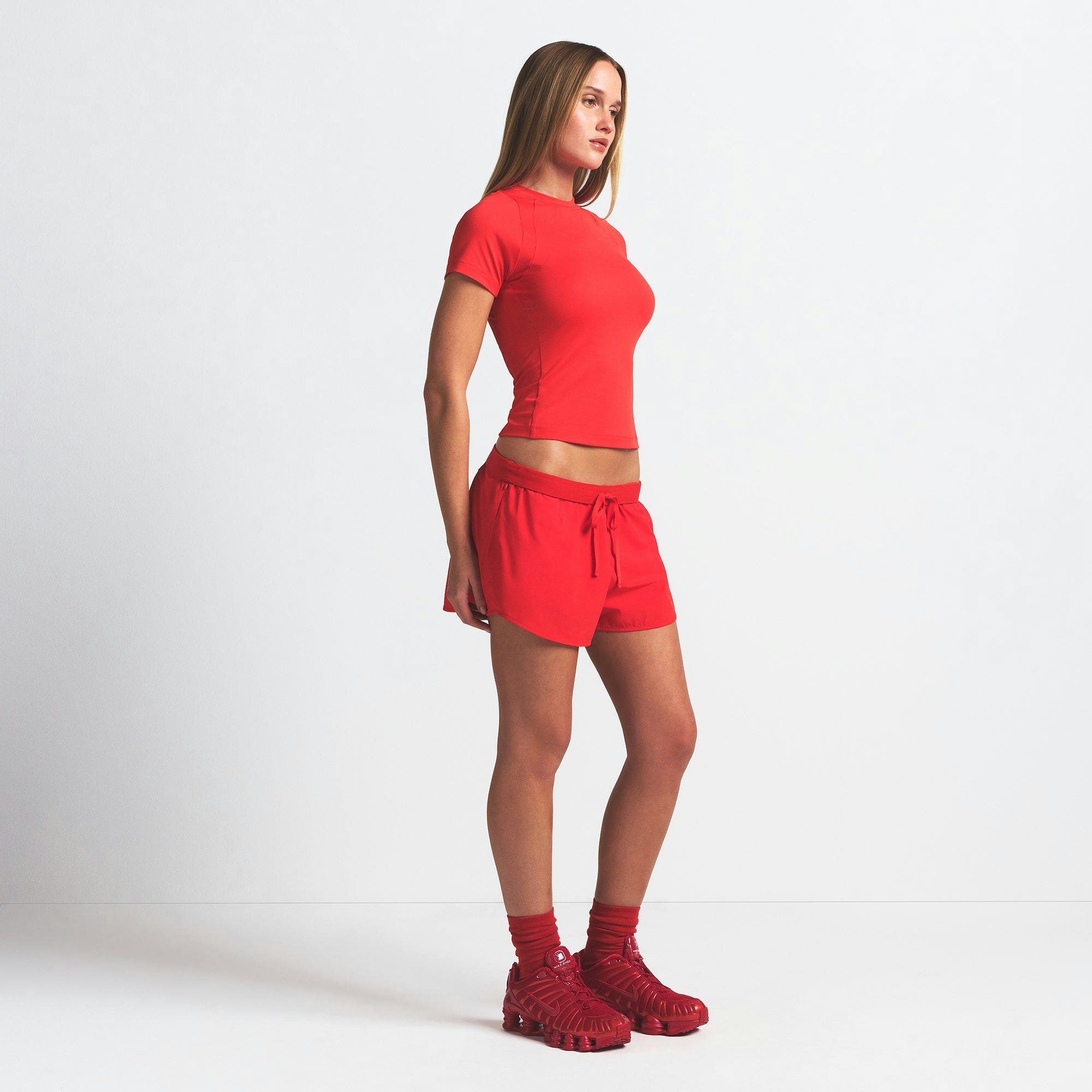 NikeSKIMS WOVEN NYLON 2.5" RUNNER SHORT | RUBY ON A MODEL SIDE VIEW @ | FOCUS: 0.0, 1.0, 0.9