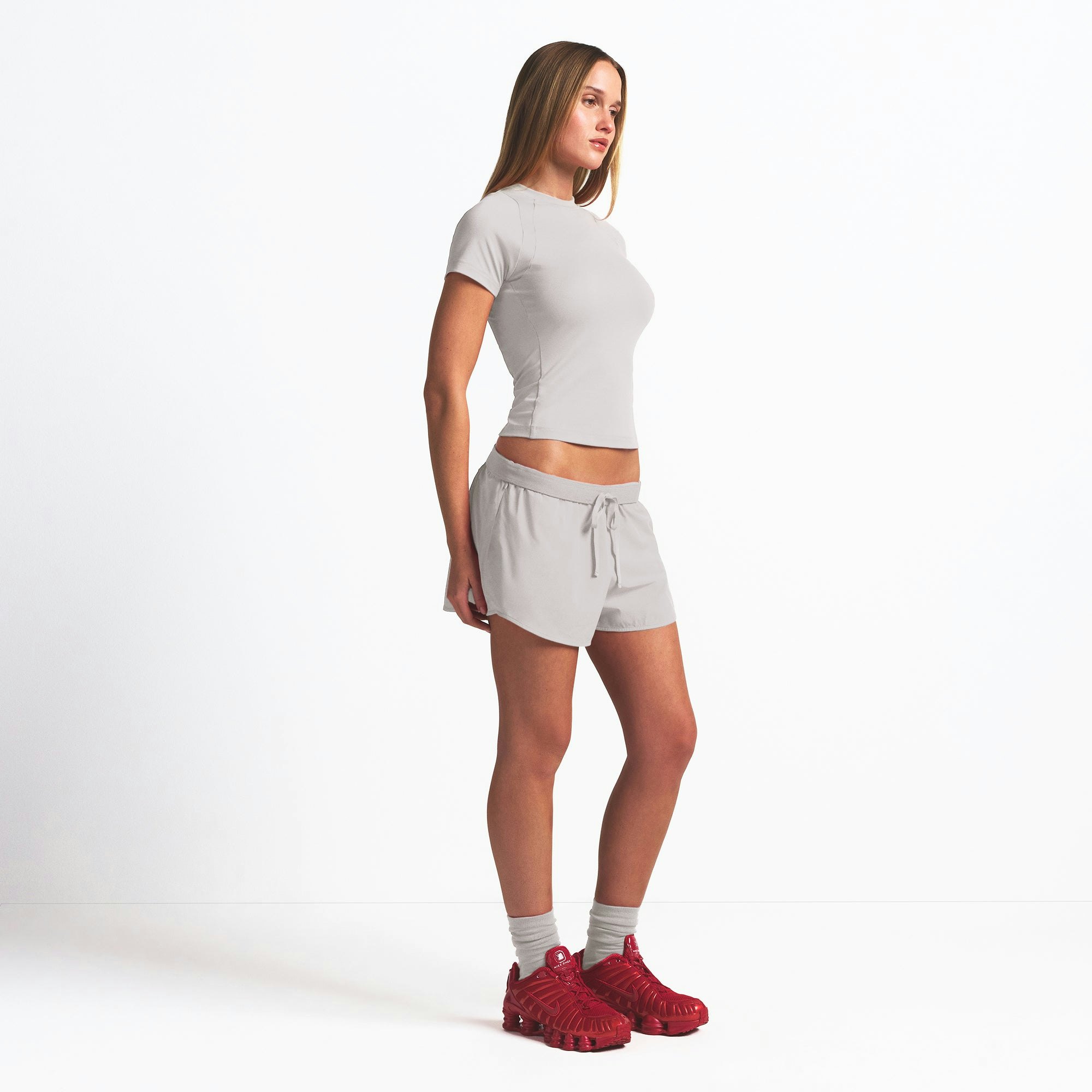 NikeSKIMS WOVEN NYLON 2.5" RUNNER SHORT | STONE ON A MODEL SIDE VIEW @ | FOCUS: 0.9, 0.1, 0.7