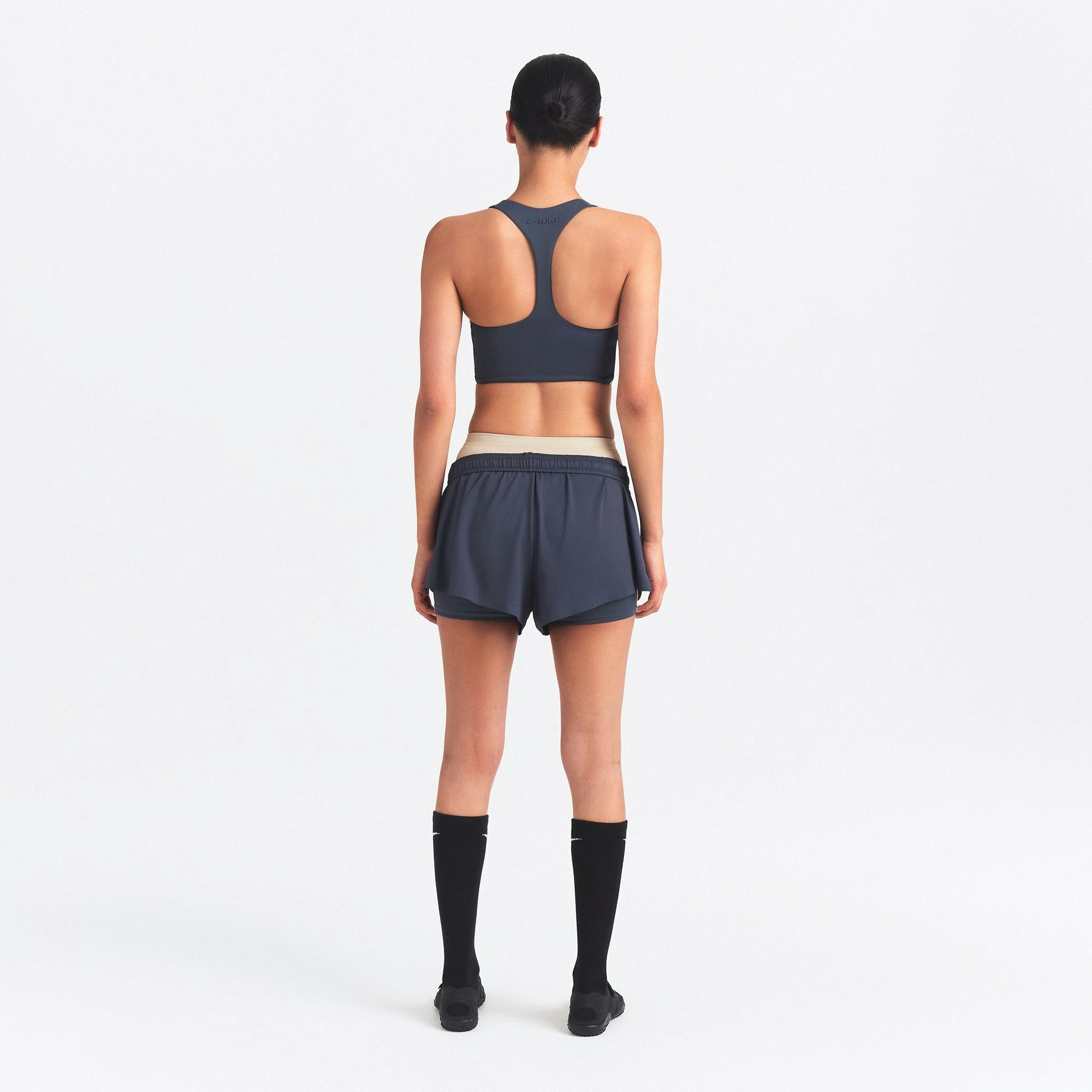 NikeSKIMS AIRY MINI SHORT | DEEP ROYAL ON A MODEL SIDE VIEW @ | FOCUS: 0.0, 1.0, 0.9