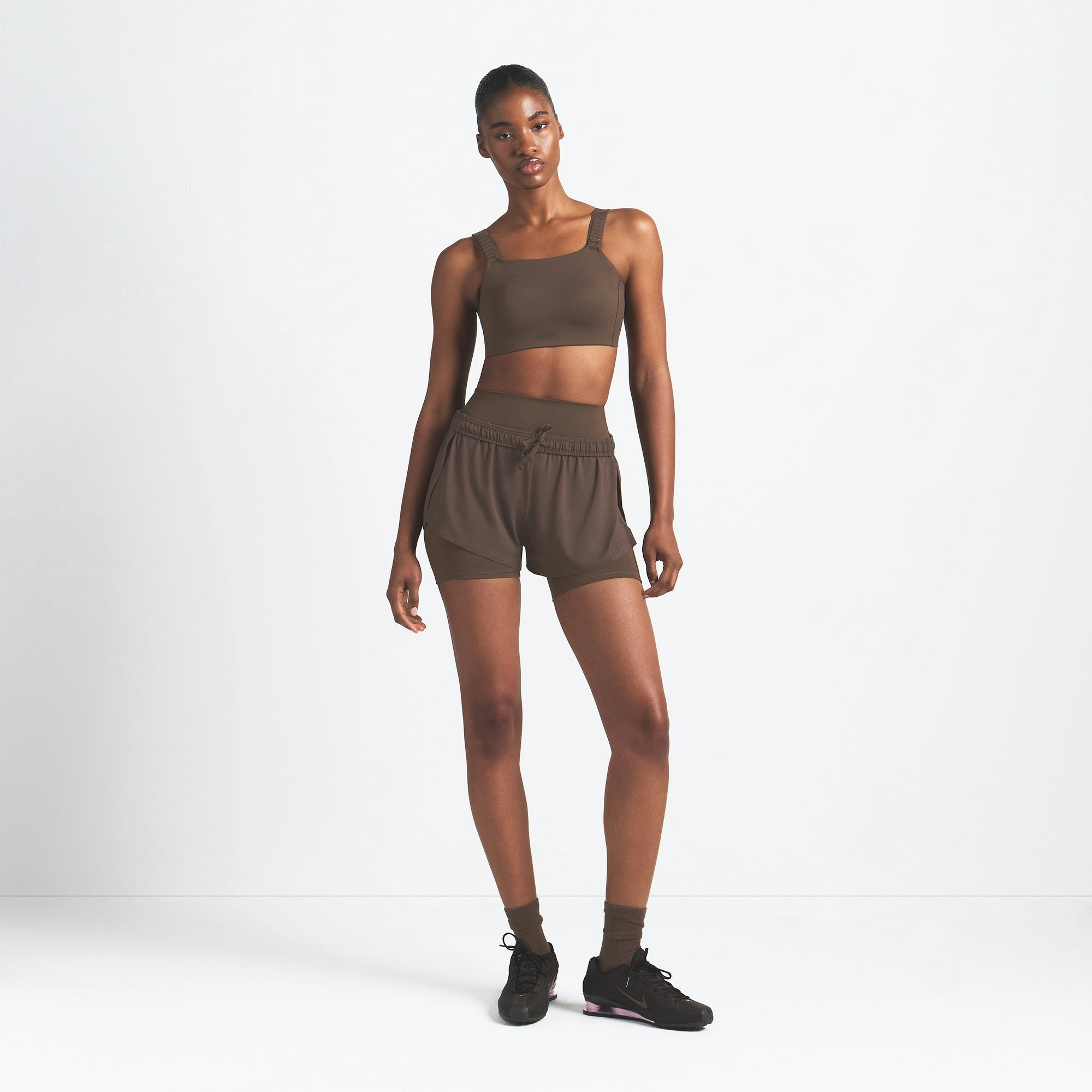 NikeSKIMS AIRY MINI SHORT | DARK SEPIA ON A MODEL FRONT VIEW @ | FOCUS: 0.9, 0.1, 0.7
