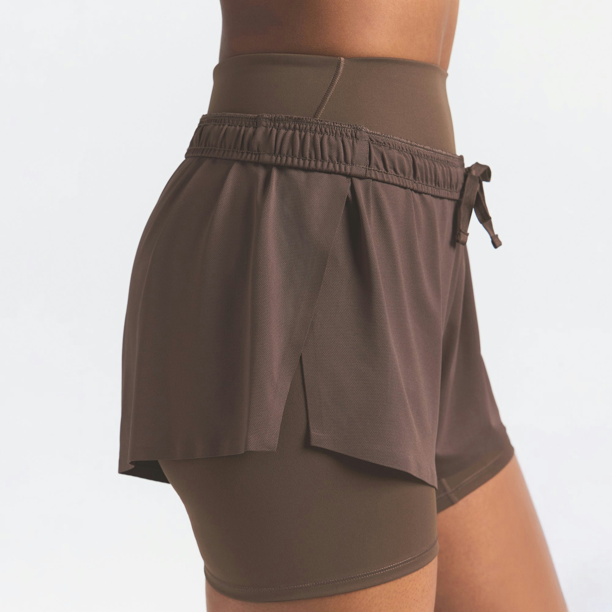 NikeSKIMS AIRY MINI SHORT | DARK SEPIA ON A MODEL SIDE VIEW @ | FOCUS: 0.9, 0.1, 0.7