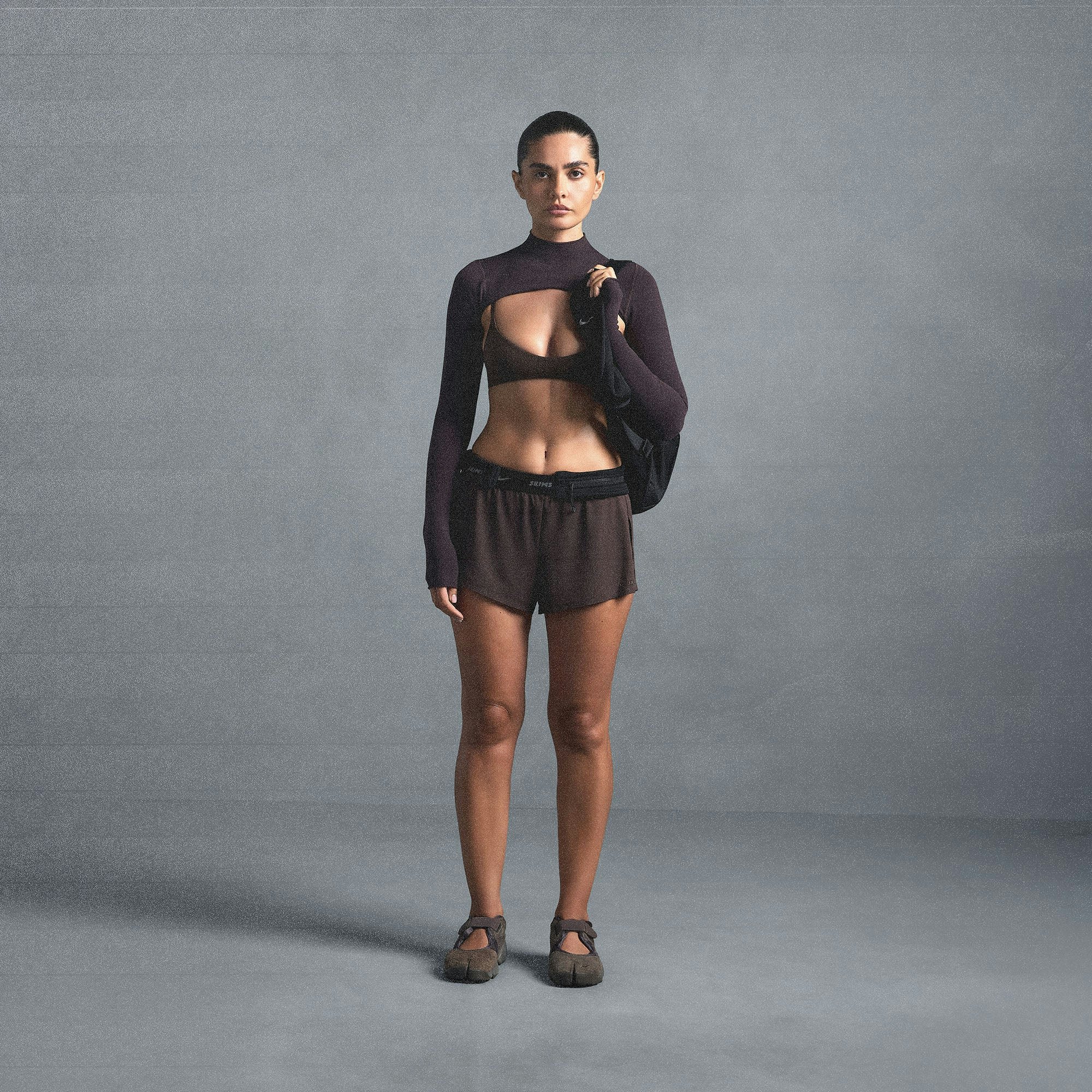 NikeSKIMS AIRY MINI SHORT | DARK SEPIA ON A MODEL SIDE VIEW @ | FOCUS: 0.0, 1.0, 0.9