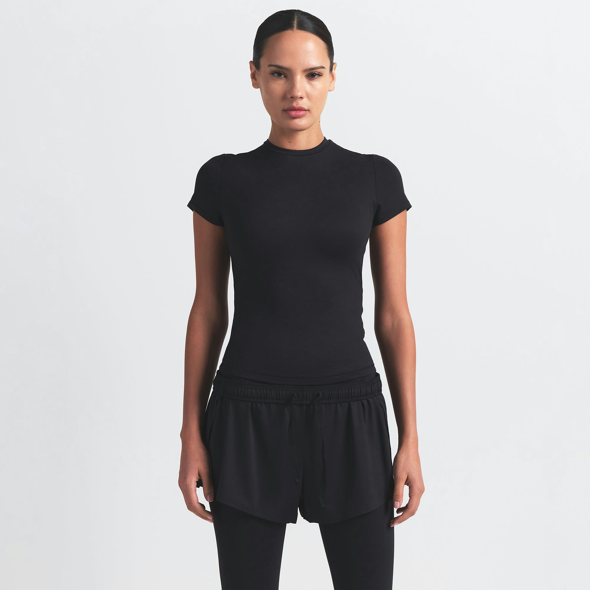 NikeSKIMS AIRY MINI SHORT | OBSIDIAN ON A MODEL FRONT VIEW @ | FOCUS: 0.9, 0.1, 0.7