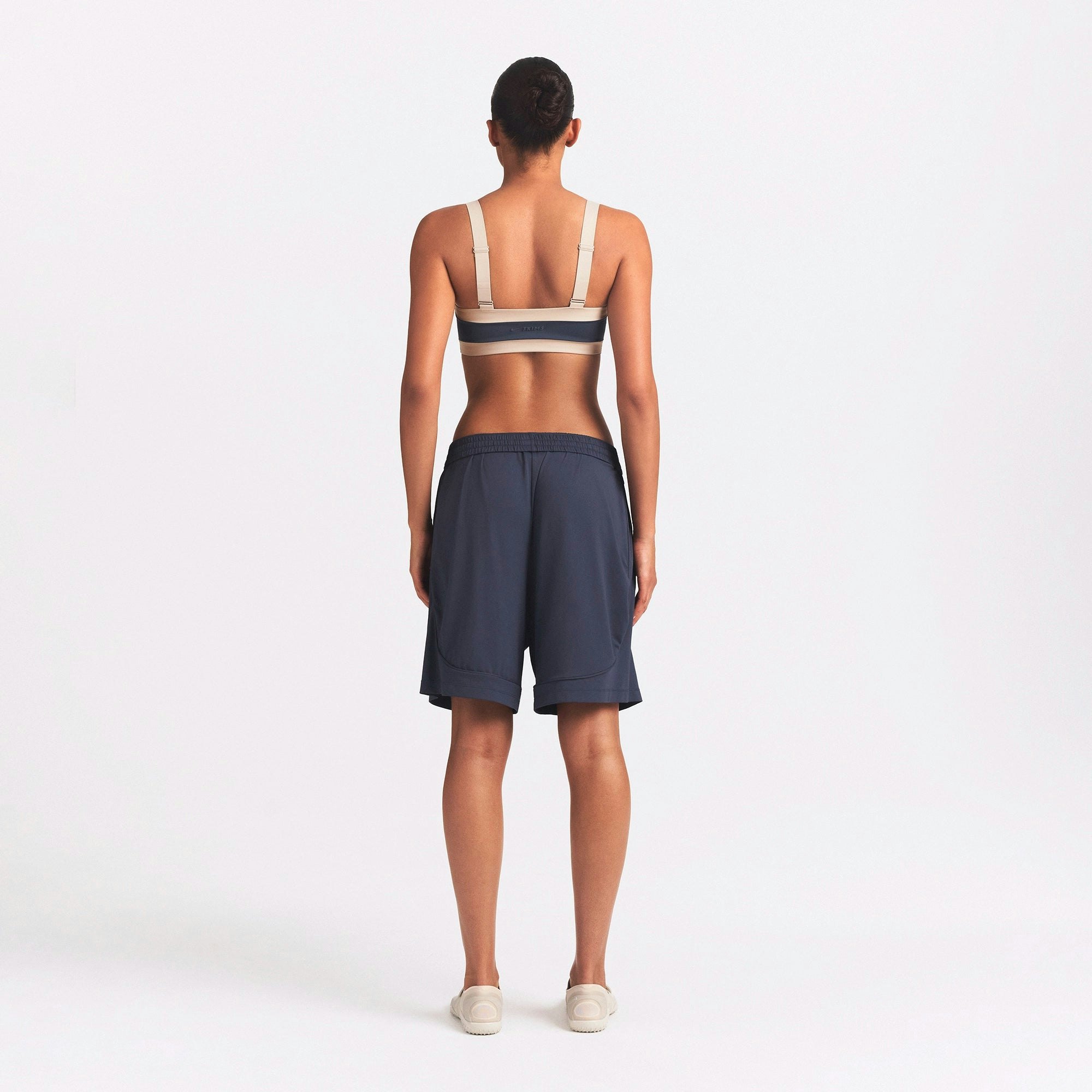 NikeSKIMS AIRY RELAXED SHORT | DEEP ROYAL ON A MODEL SIDE VIEW @ | FOCUS: 0.0, 1.0, 0.9
