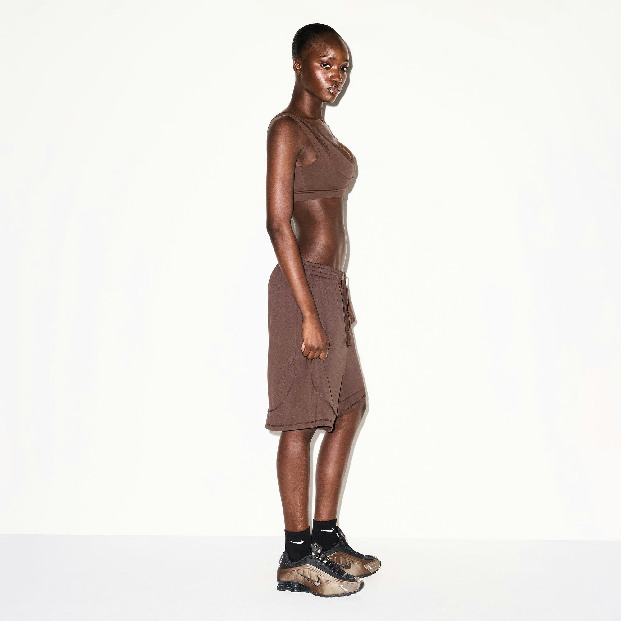 NikeSKIMS AIRY RELAXED SHORT | DARK SEPIA ON A MODEL SIDE VIEW @ | FOCUS: 0.0, 1.0, 0.9