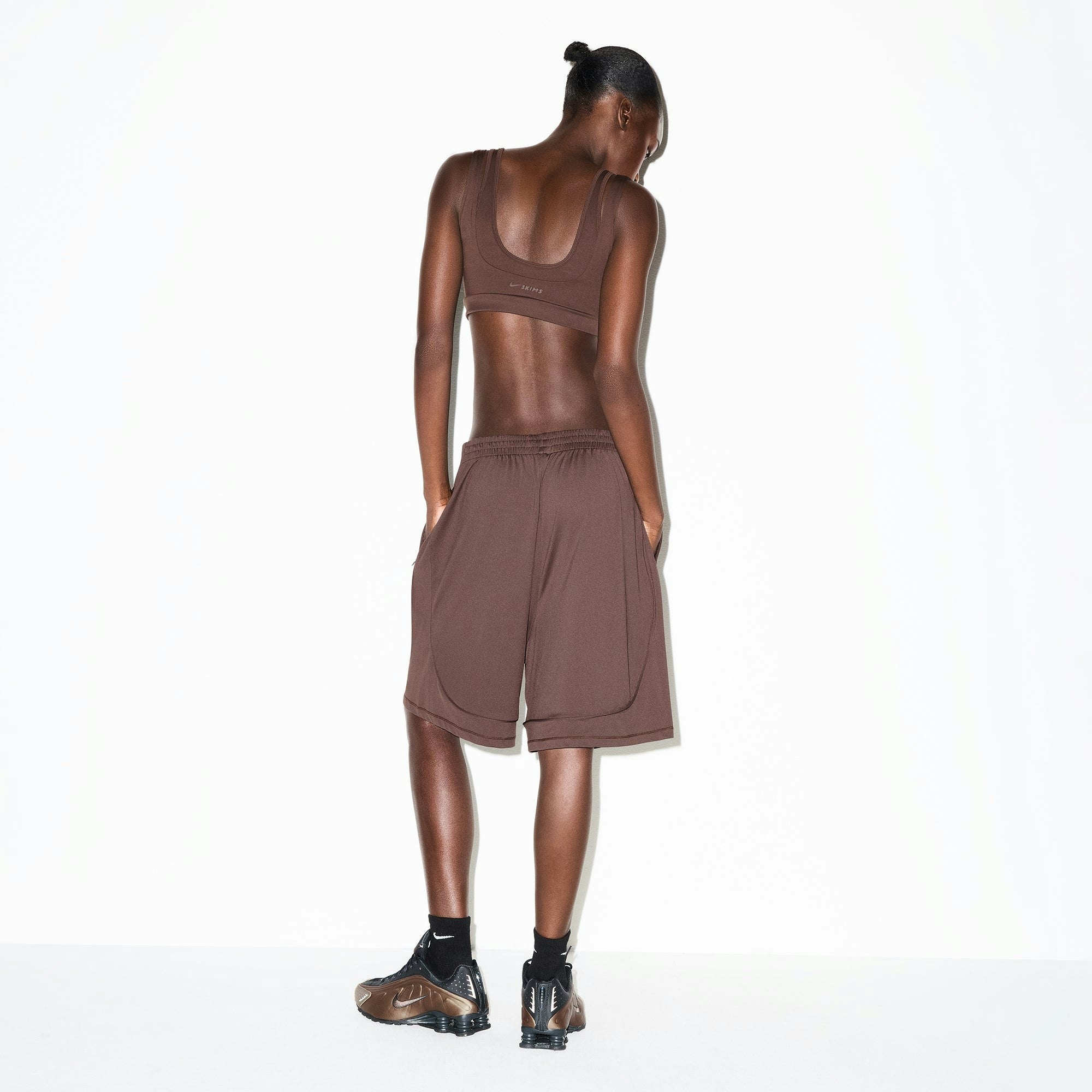 NikeSKIMS AIRY RELAXED SHORT | DARK SEPIA ON A MODEL BACK VIEW @ | FOCUS: 0.0, 1.0, 0.9
