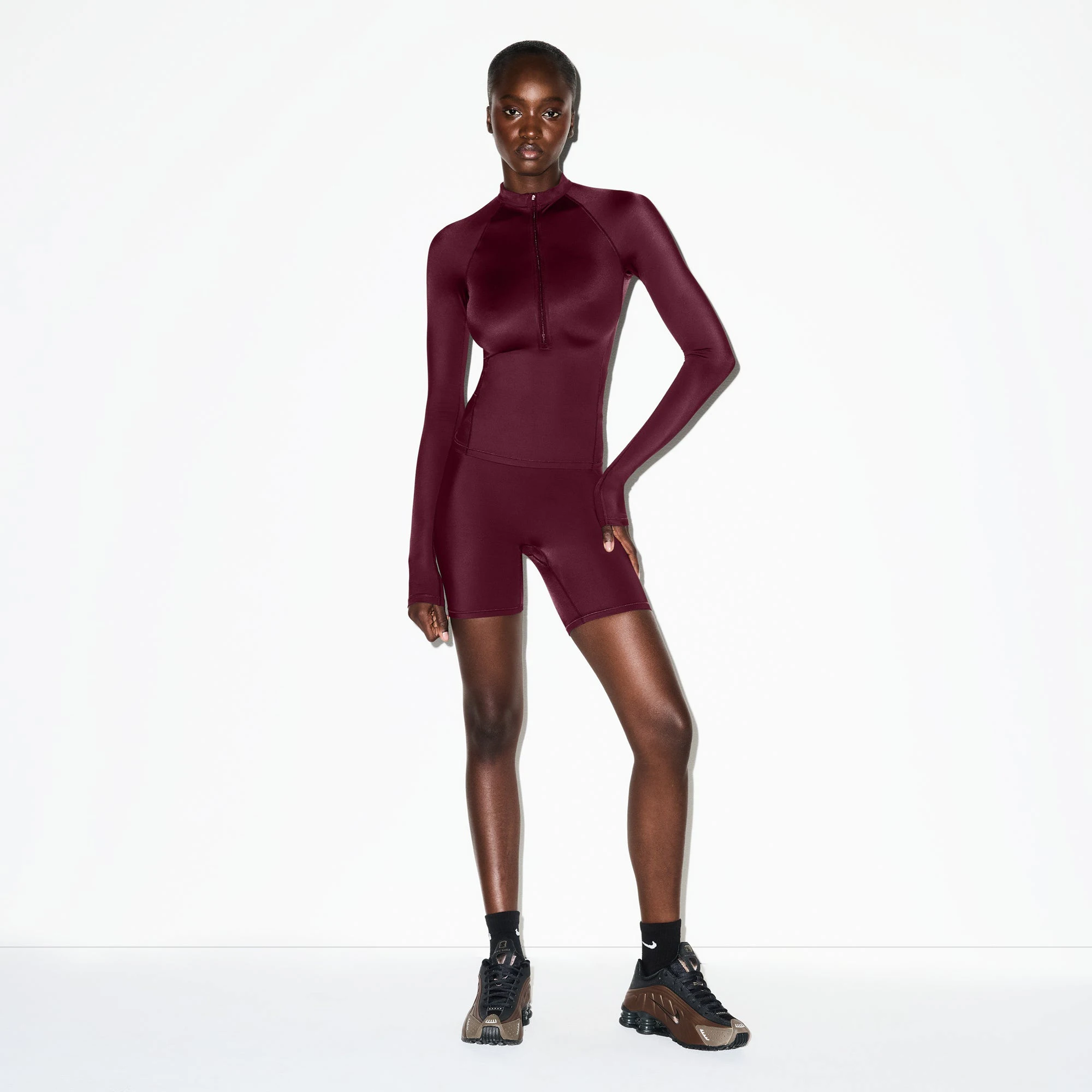 NikeSKIMS SHINE BONDED WAIST 5" BIKER SHORT | CURRANT ON A MODEL FRONT VIEW @ | FOCUS: 0.0, 1.0, 0.9