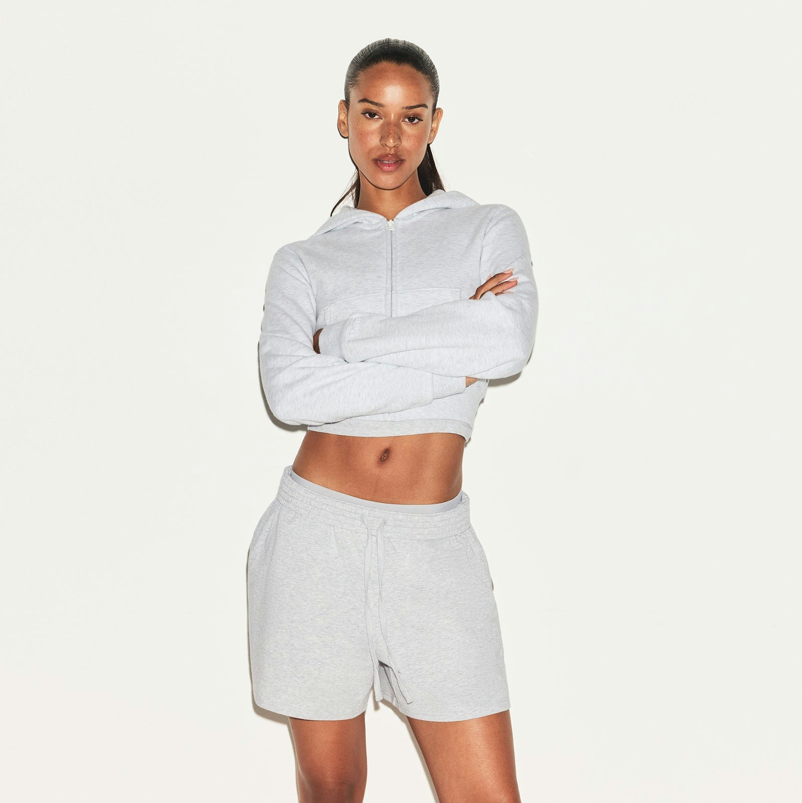 COTTON JERSEY CLASSIC SHORT | LIGHT HEATHER GREY ON A MODEL SIDE VIEW | FOCUS: 0.0, 1.0, 0.9