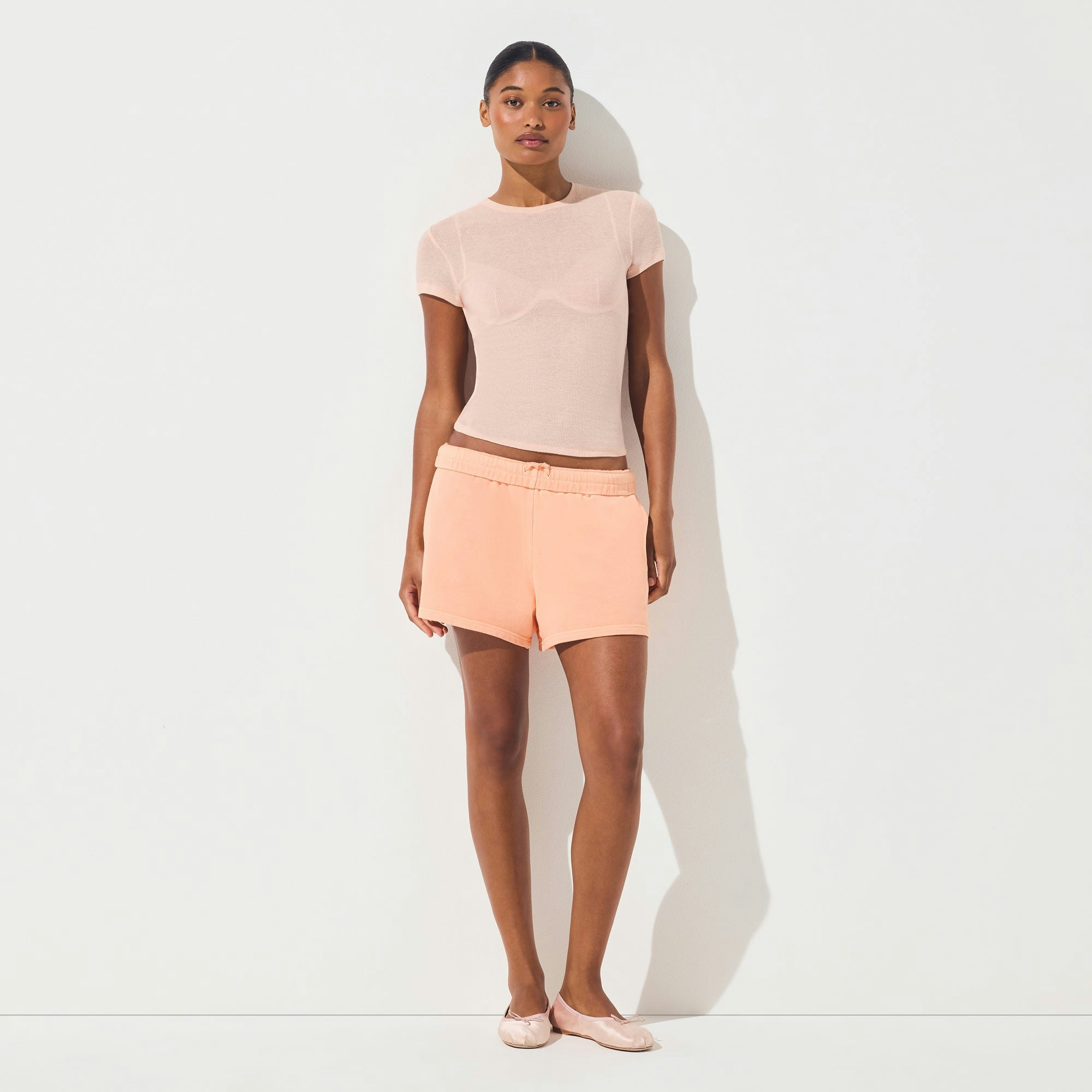 FRENCH TERRY CLASSIC SHORT | CANTALOUPE ON A MODEL FRONT VIEW | FOCUS: 0.0, 1.0, 0.9