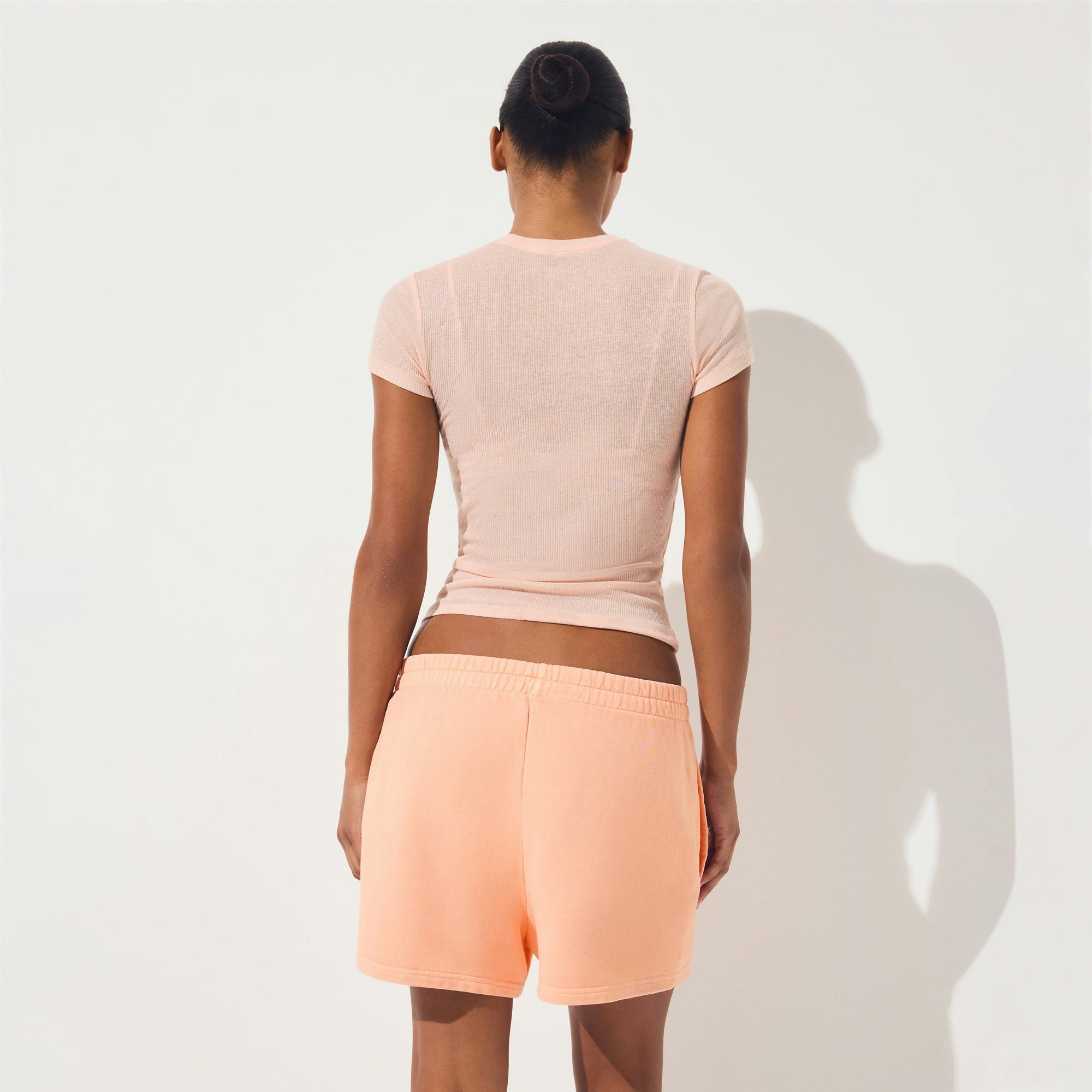 FRENCH TERRY CLASSIC SHORT | CANTALOUPE ON A MODEL SIDE VIEW | FOCUS: 0.0, 1.0, 0.9