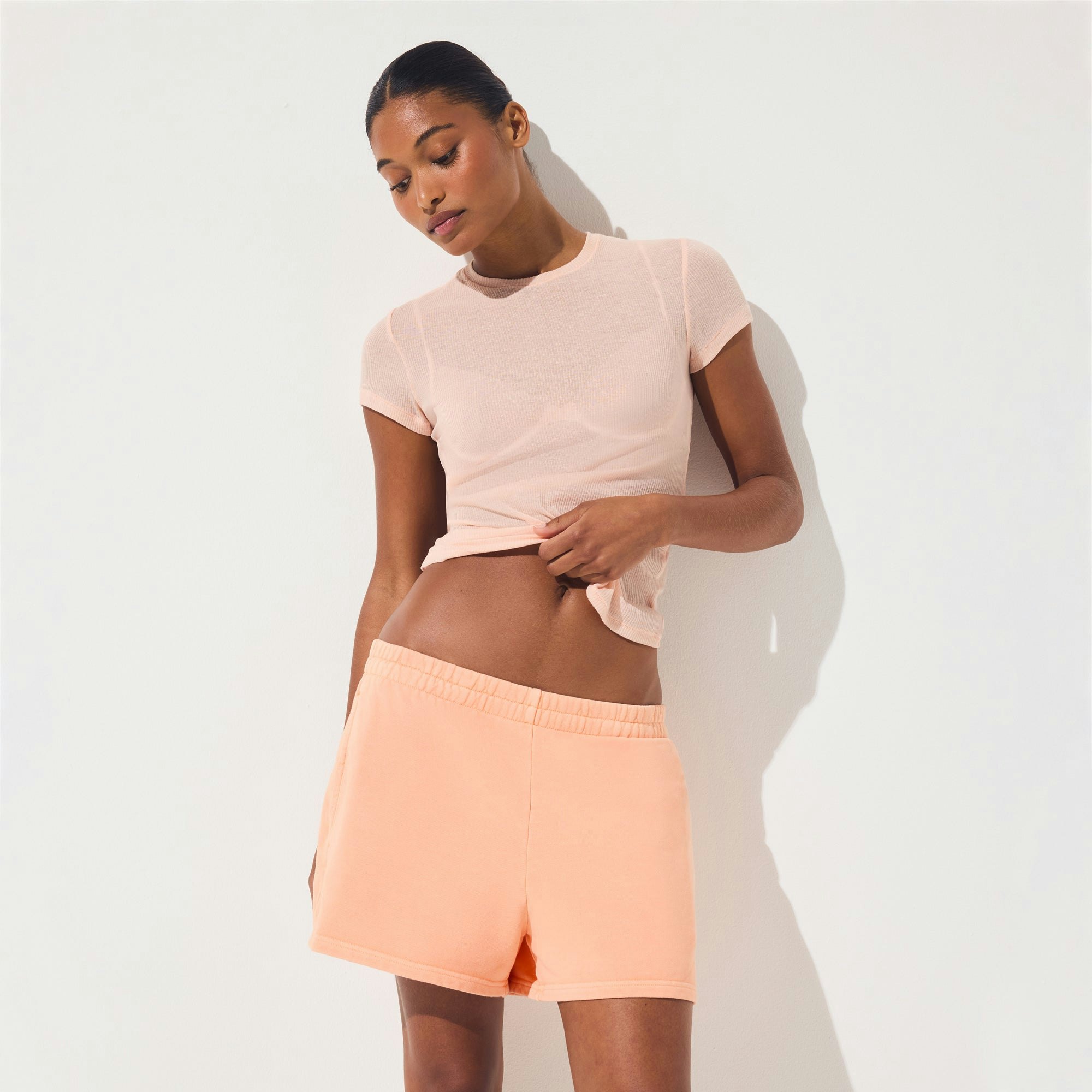 FRENCH TERRY CLASSIC SHORT | CANTALOUPE ON A MODEL SIDE VIEW | FOCUS: 0.0, 1.0, 0.9