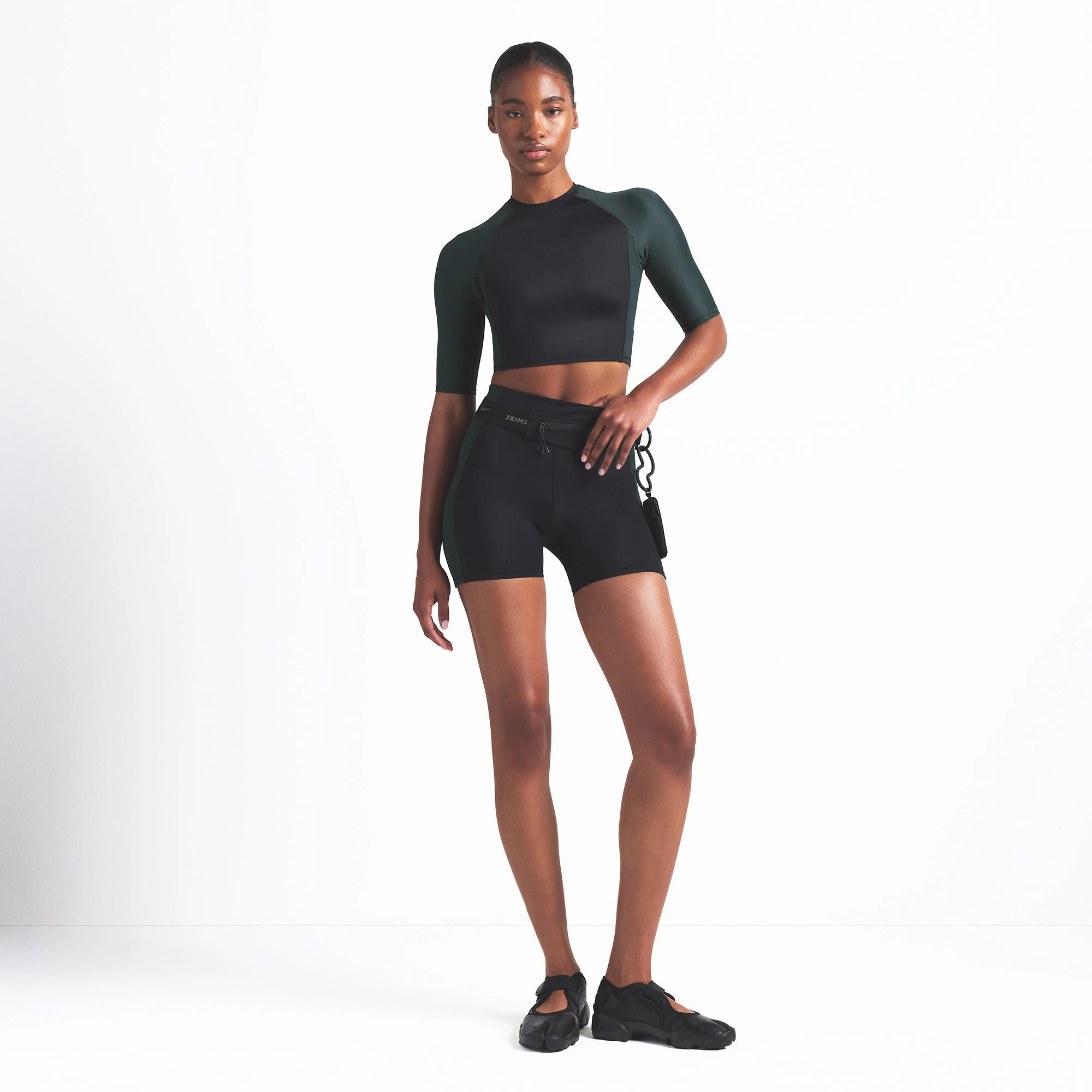 NikeSKIMS SHINE 5" BIKER SHORT | OBSIDIAN AND DARK TEAL ON A MODEL FRONT VIEW @ | FOCUS: 0.0, 1.0, 0.9