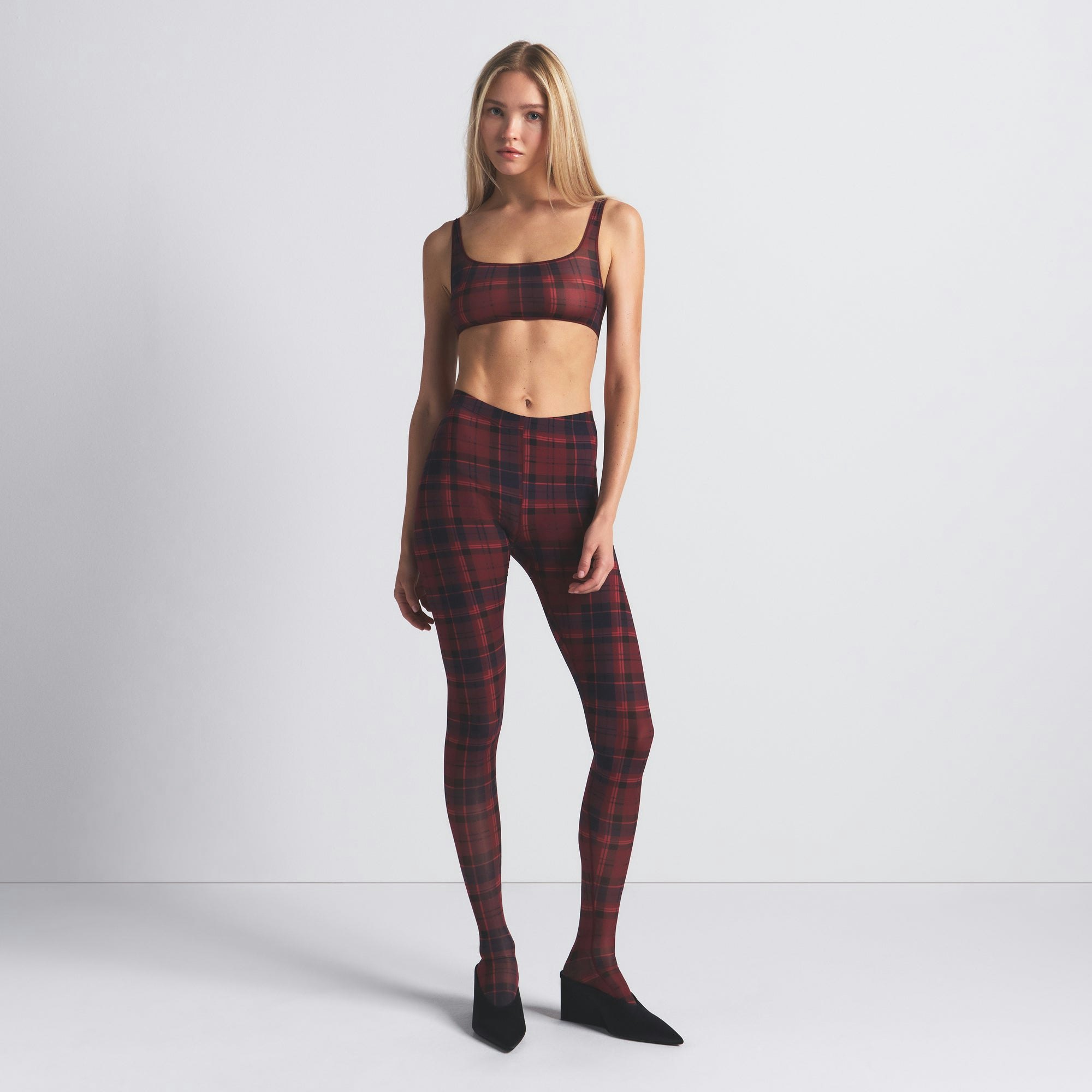 MILKY SHEER FOOTED LEGGING | MERLOT NAVY PLAID ON A MODEL FRONT VIEW @ | FOCUS: 0.0, 1.0, 0.9