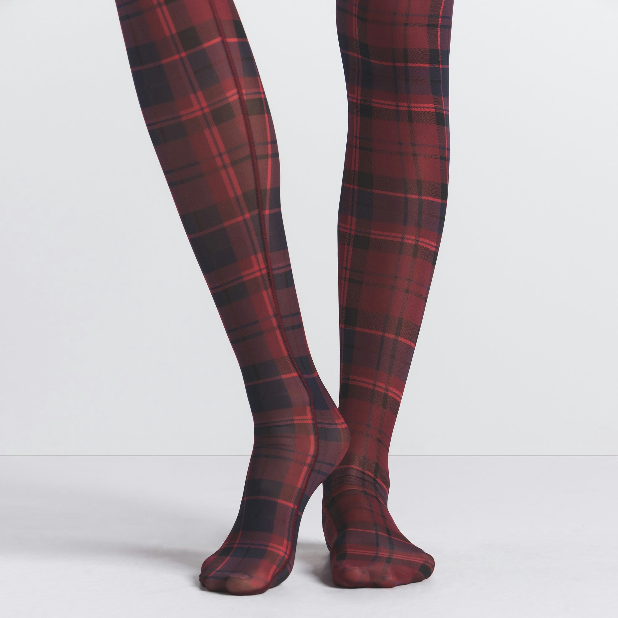 MILKY SHEER FOOTED LEGGING | MERLOT NAVY PLAID ON A MODEL SIDE VIEW @ | FOCUS: 0.0, 1.0, 0.9