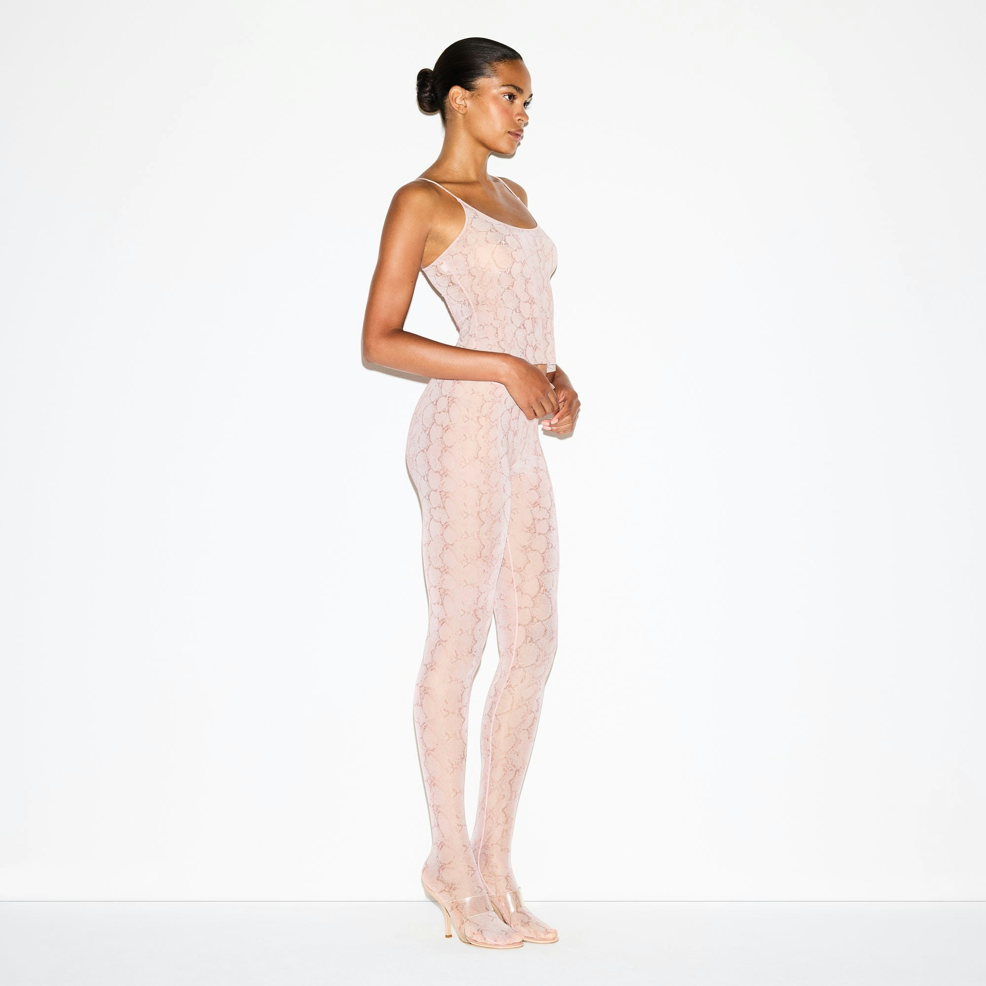 MILKY SHEER FOOTED LEGGING | ROSE PASTEL SNAKE PRINT ON A MODEL FRONT VIEW @ | FOCUS: 0.0, 1.0, 0.9