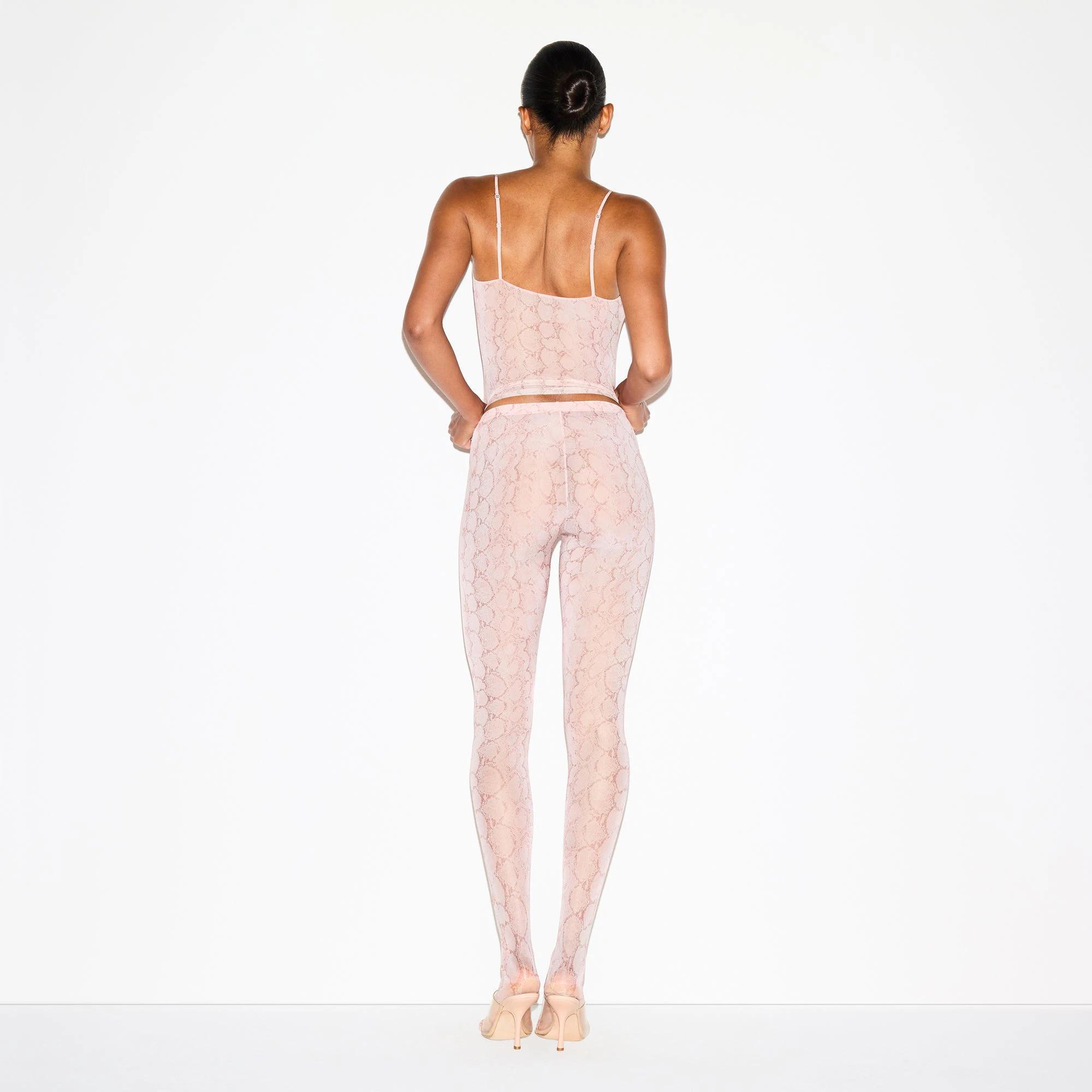 MILKY SHEER FOOTED LEGGING | ROSE PASTEL SNAKE PRINT ON A MODEL FRONT VIEW @ | FOCUS: 0.0, 1.0, 0.9