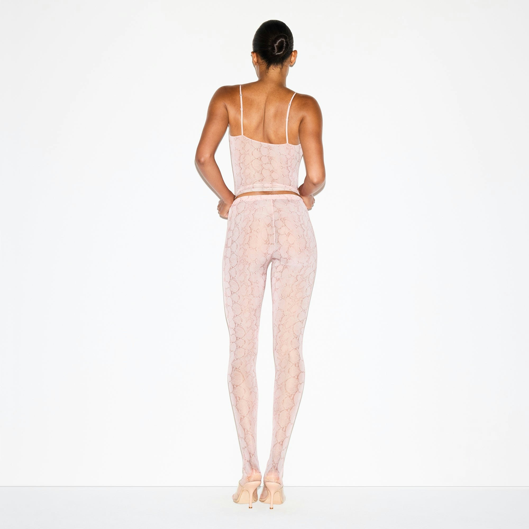 MILKY SHEER FOOTED LEGGING | ROSE PASTEL SNAKE PRINT ON A MODEL FRONT VIEW @ | FOCUS: 0.0, 1.0, 0.9
