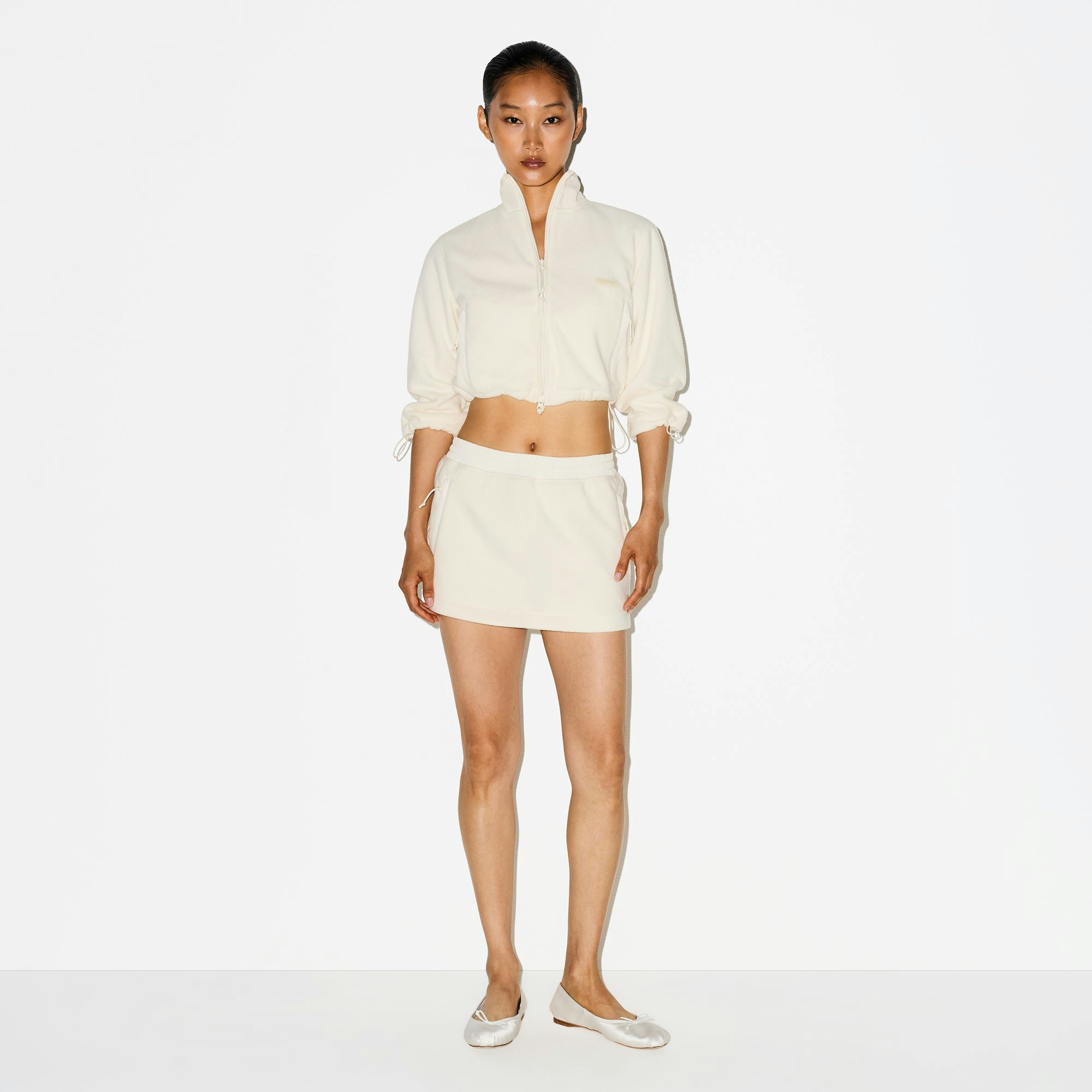 OUTDOOR FLEECE MINI SKIRT | ECRU ON A MODEL FRONT VIEW @ | FOCUS: 0.0, 1.0, 0.9