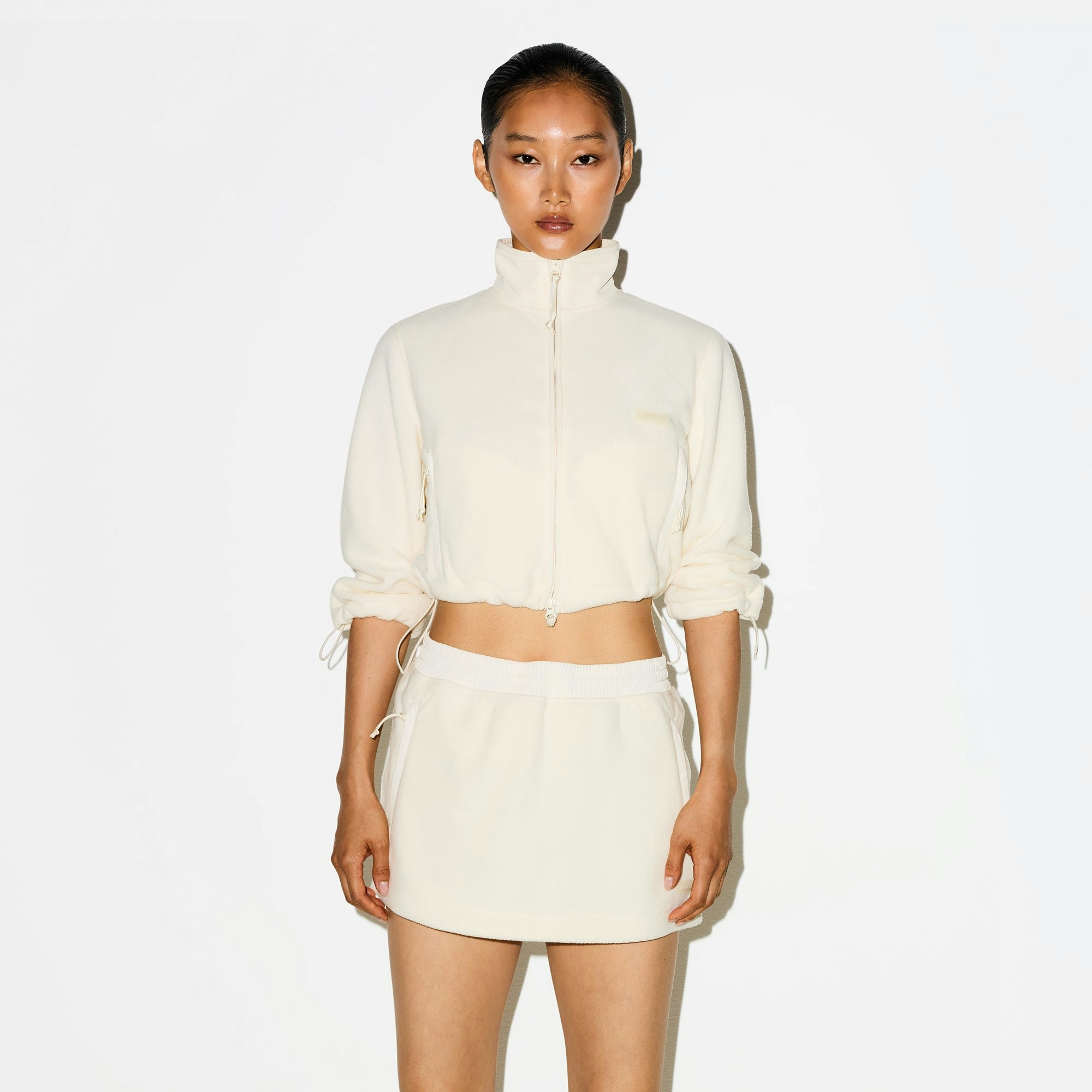 OUTDOOR FLEECE MINI SKIRT | ECRU ON A MODEL SIDE VIEW @ | FOCUS: 0.0, 1.0, 0.9