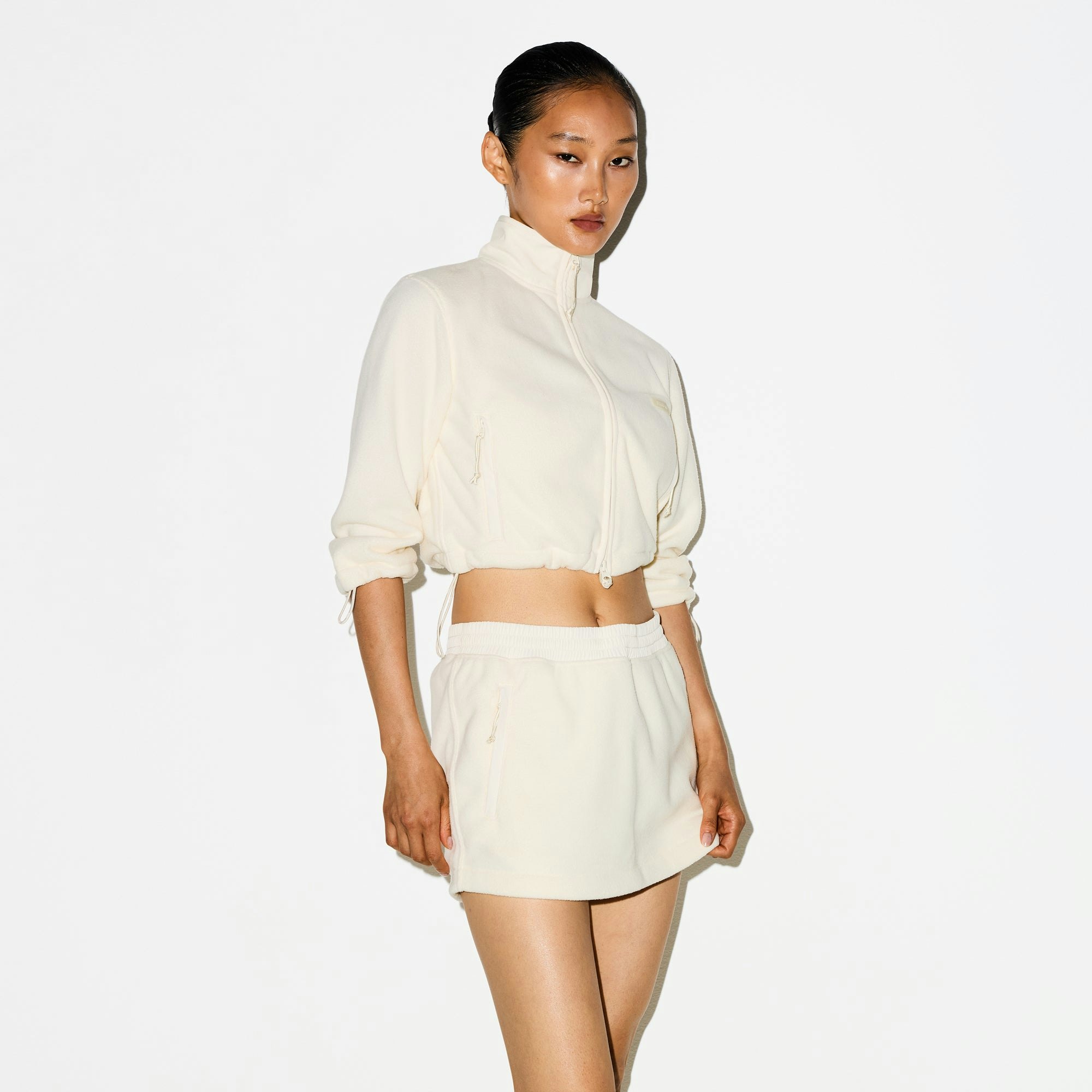 OUTDOOR FLEECE MINI SKIRT | ECRU ON A MODEL SIDE VIEW @ | FOCUS: 0.0, 1.0, 0.9