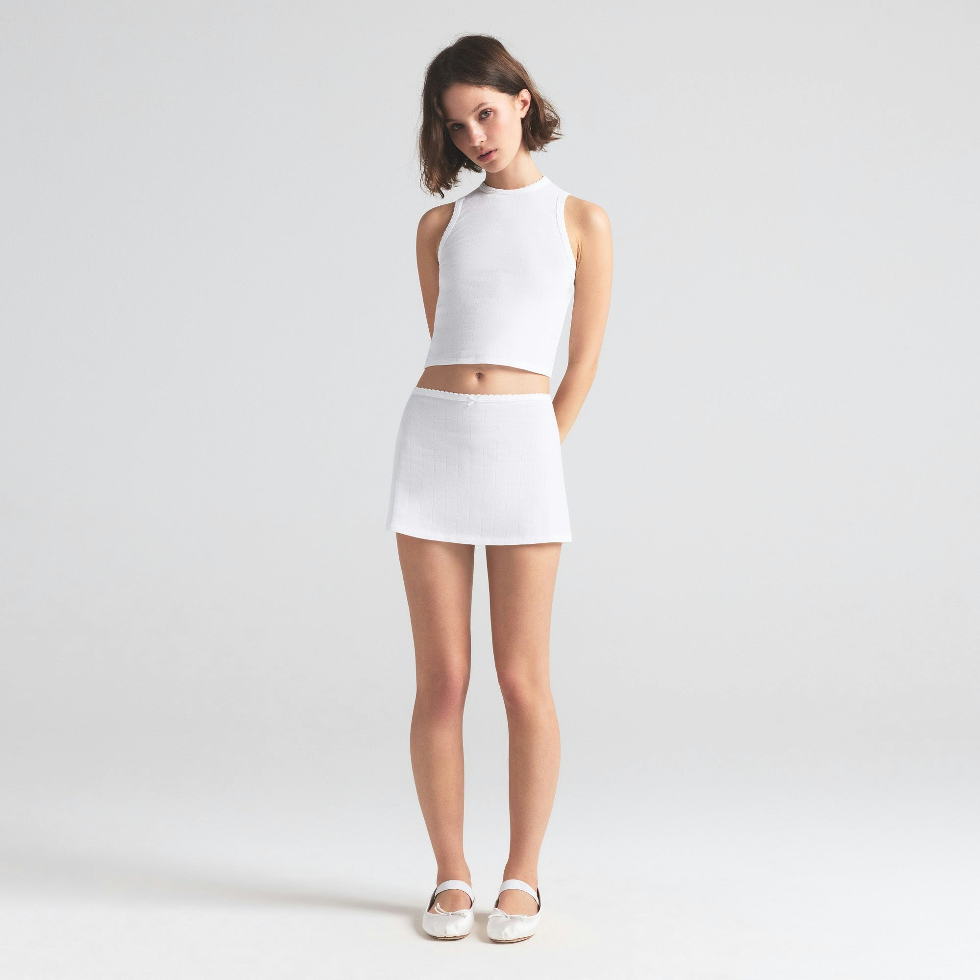 DROP NEEDLE POINTELLE MINI SKIRT | SNOW ON A MODEL FRONT VIEW | FOCUS: 0.0, 1.0, 0.9