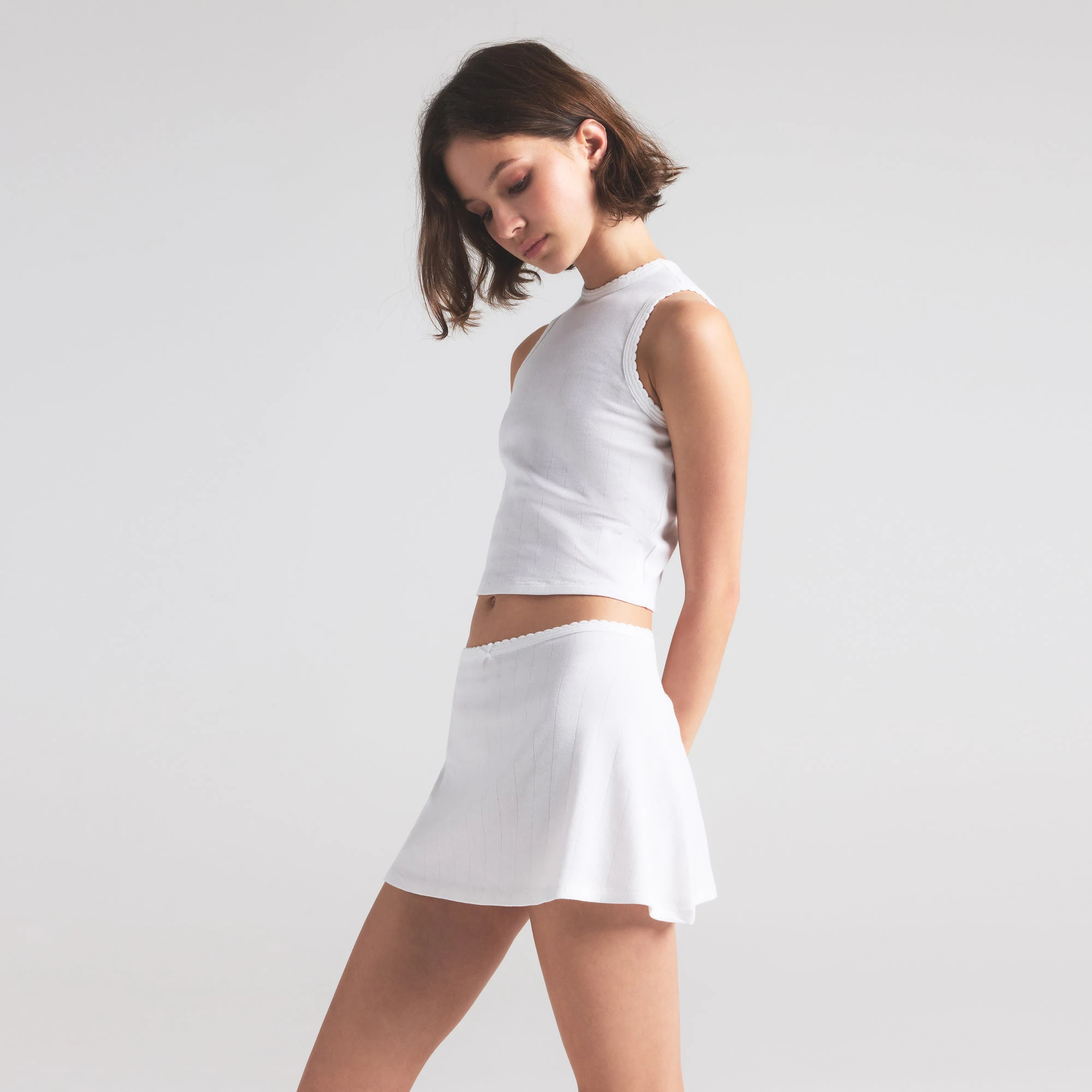 DROP NEEDLE POINTELLE MINI SKIRT | SNOW ON A MODEL SIDE VIEW | FOCUS: 0.0, 1.0, 0.9