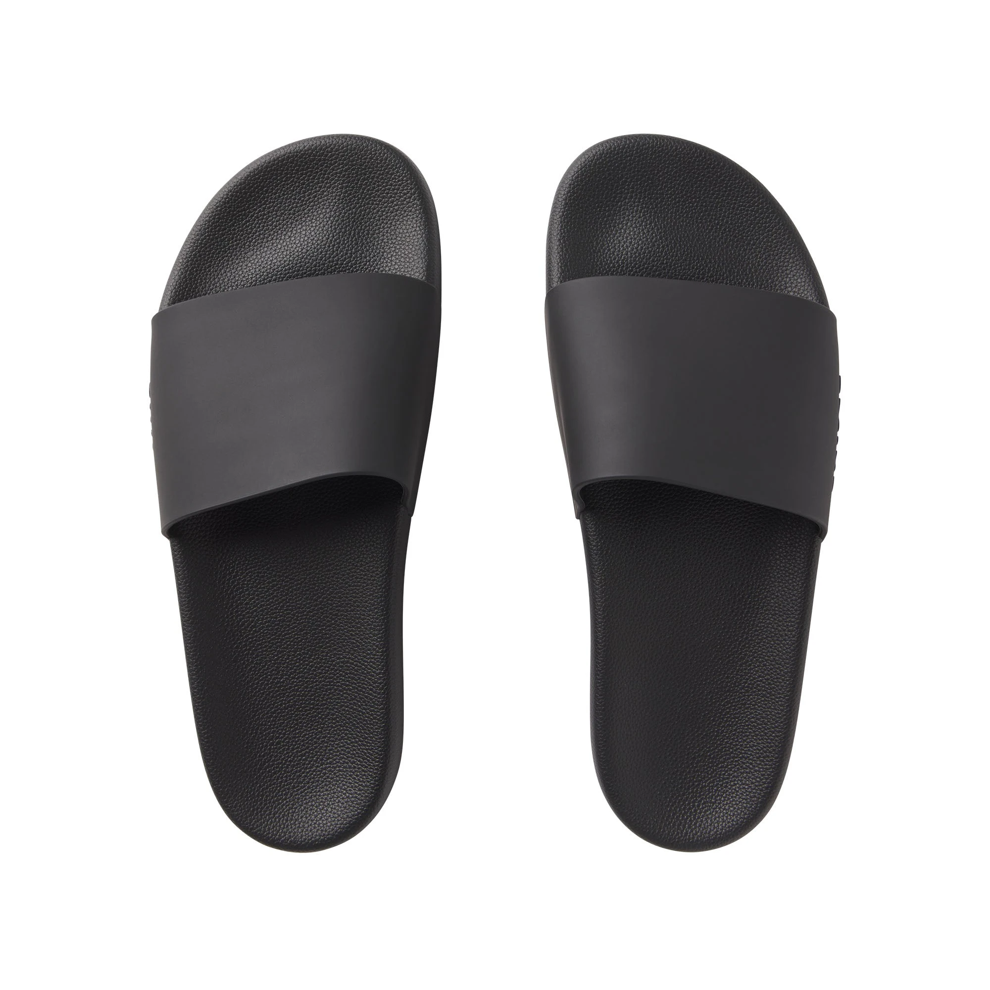 SKIMS ACCESSORIES MENS POOL SLIDE | ONYX FLAT ON A WHITE BACKGROUND | FLT