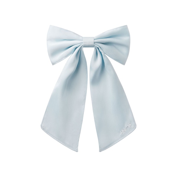 SATIN JUMBO BOW CLIP | BABY BLUE LAYS FLAT ON A WHITE BACKGROUND @ | FOCUS: 0.0, 1.0, 0.9