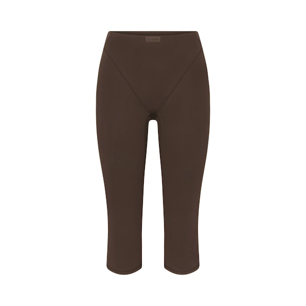 NikeSKIMS MATTE 17" V-LINE CROP LEGGING | DARK SEPIA FLAT ON A WHITE BACKGROUND | FLT