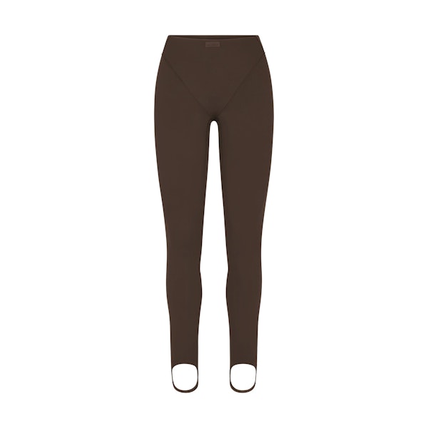 NikeSKIMS MATTE V-LINE STIRRUP LEGGING | DARK SEPIA FLAT ON A WHITE BACKGROUND | FLT