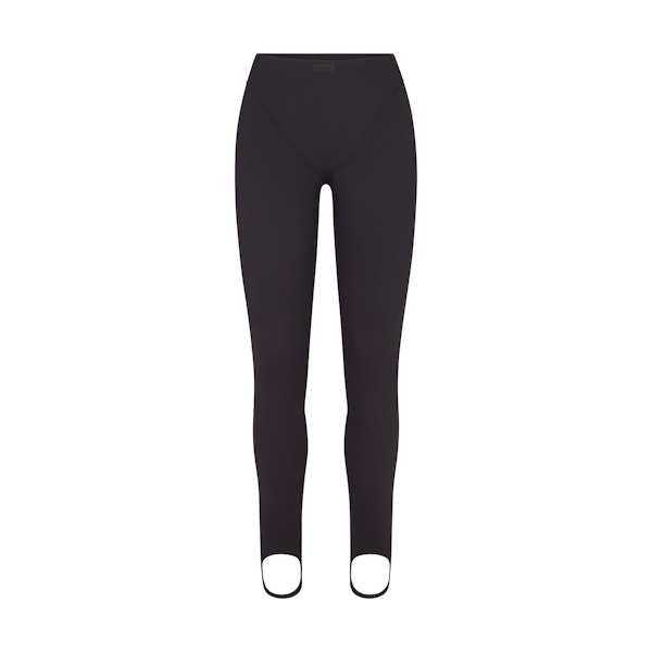 NikeSKIMS MATTE V-LINE STIRRUP LEGGING | OBSIDIAN FLAT ON A WHITE BACKGROUND | FLT