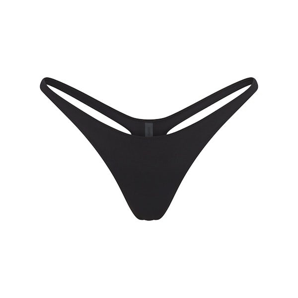 SIGNATURE SWIM THONG BIKINI BOTTOM | ONYX FLAT ON A WHITE BACKGROUND | FLT