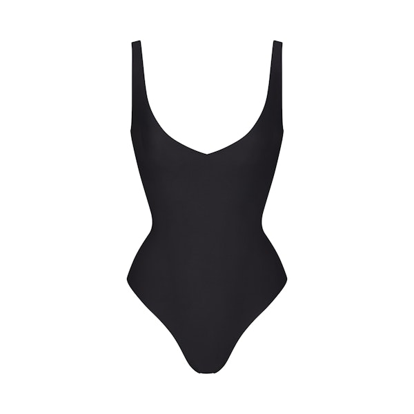 SKIMS BODY UNLINED PLUNGE THONG BODYSUIT | ONYX (SHAPEWEAR BODYSUITS, SHAPEWEAR) LAYS FLAT ON A WHITE BACKGROUND | FLT