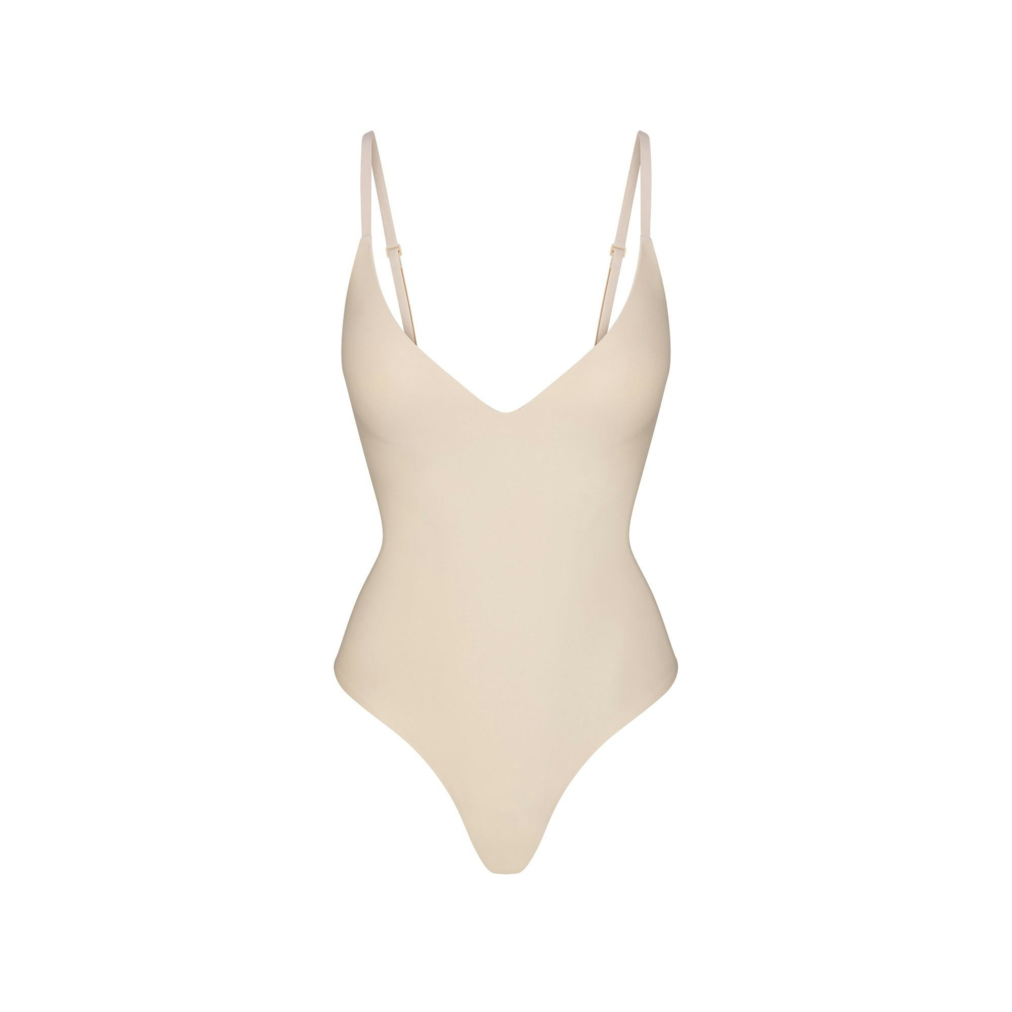 SKIMS BODY PUSH-UP THONG BODYSUIT | SAND (SHAPEWEAR BODYSUITS, SHAPEWEAR) FLAT ON A WHITE BACKGROUND | FLT