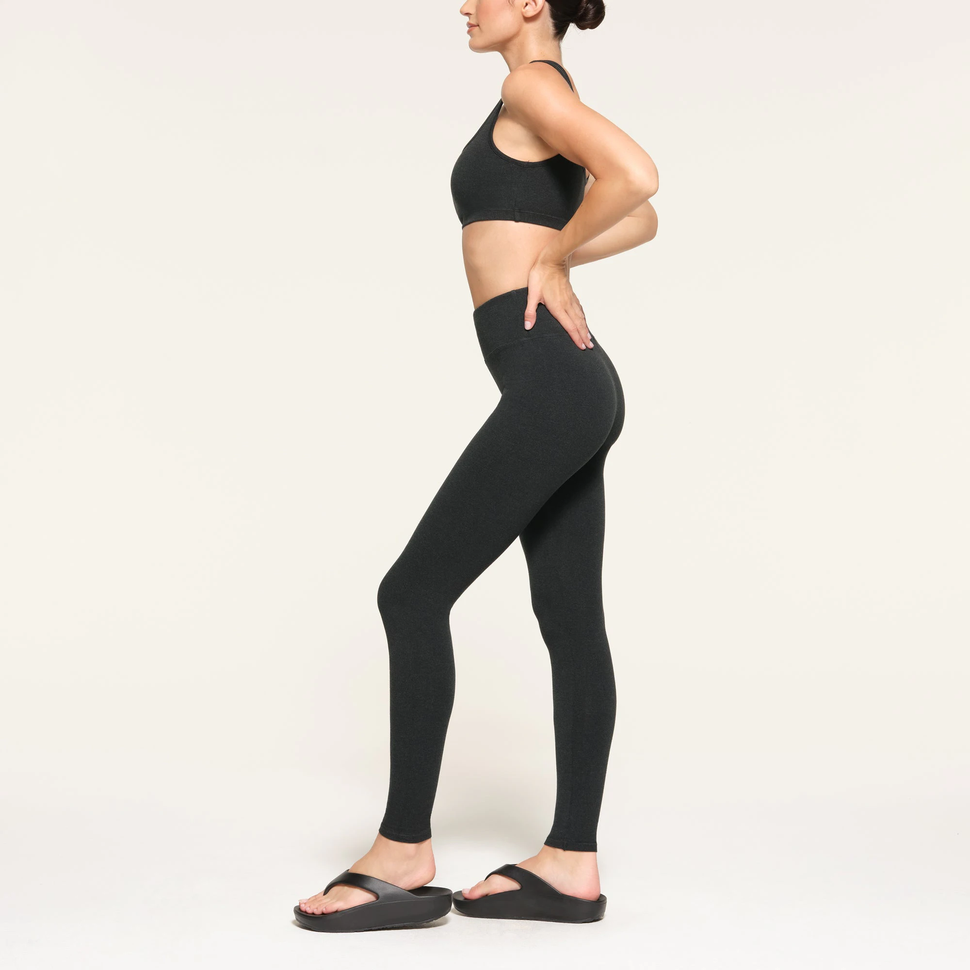OUTDOOR HIGH-WAISTED LEGGING WORN BY A MODEL IN SIDE VIEW