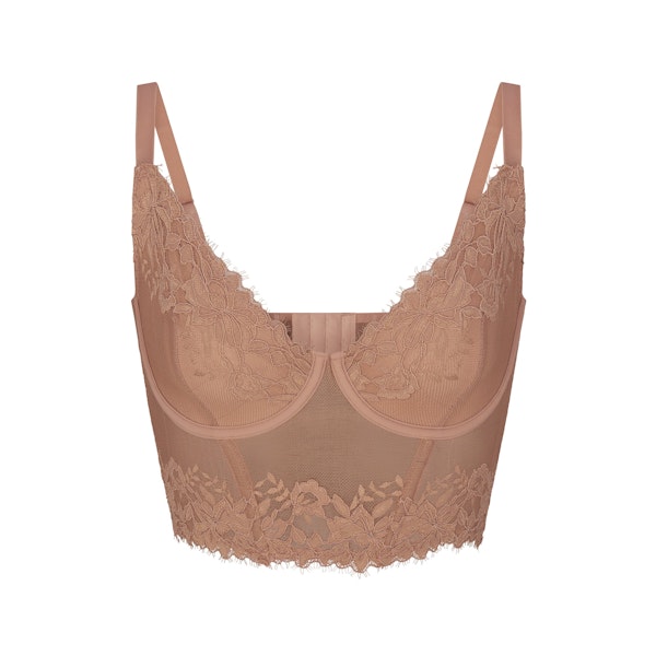 SKIMS LACE LINED DEMI CORSET LAYS FLAT ON A WHITE BACKGROUND | FLT