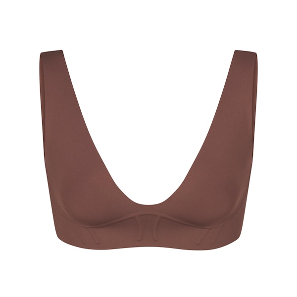 BONDED CORSET PLUNGE BRALETTE LAYS FLAT ON A WHITE BACKGROUND