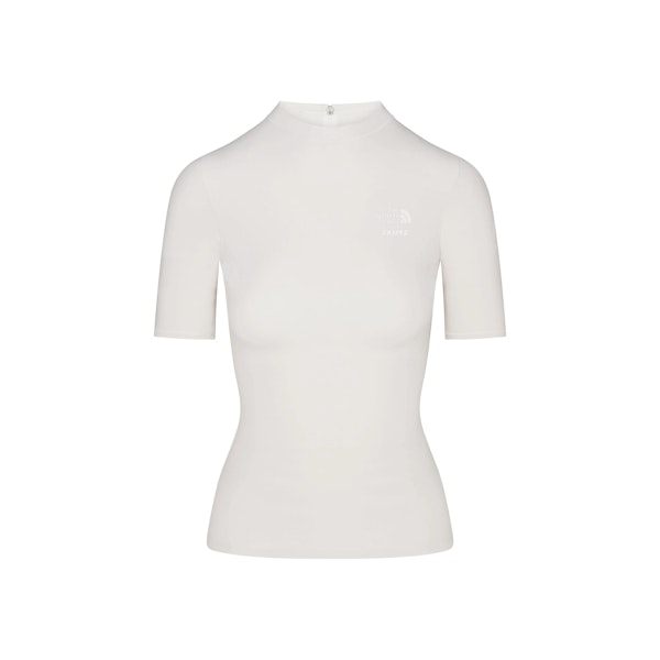 THE NORTH FACE X SKIMS REFINA SHORT SLEEVE TOP | BONE FLAT ON A WHITE BACKGROUND | FLT