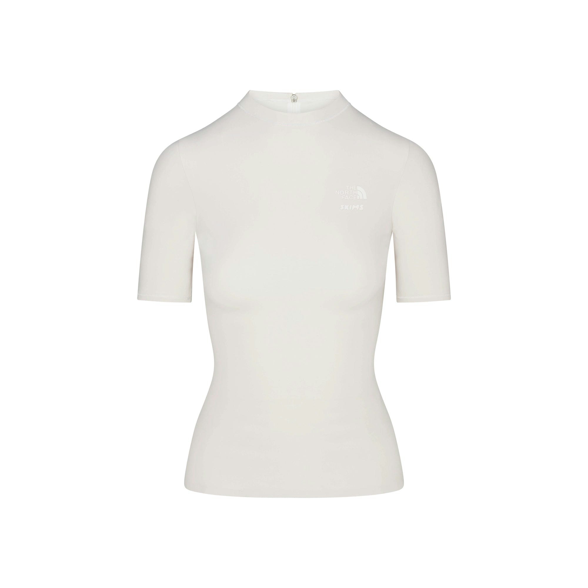 THE NORTH FACE X SKIMS REFINA SHORT SLEEVE TOP | BONE FLAT ON A WHITE BACKGROUND | FLT