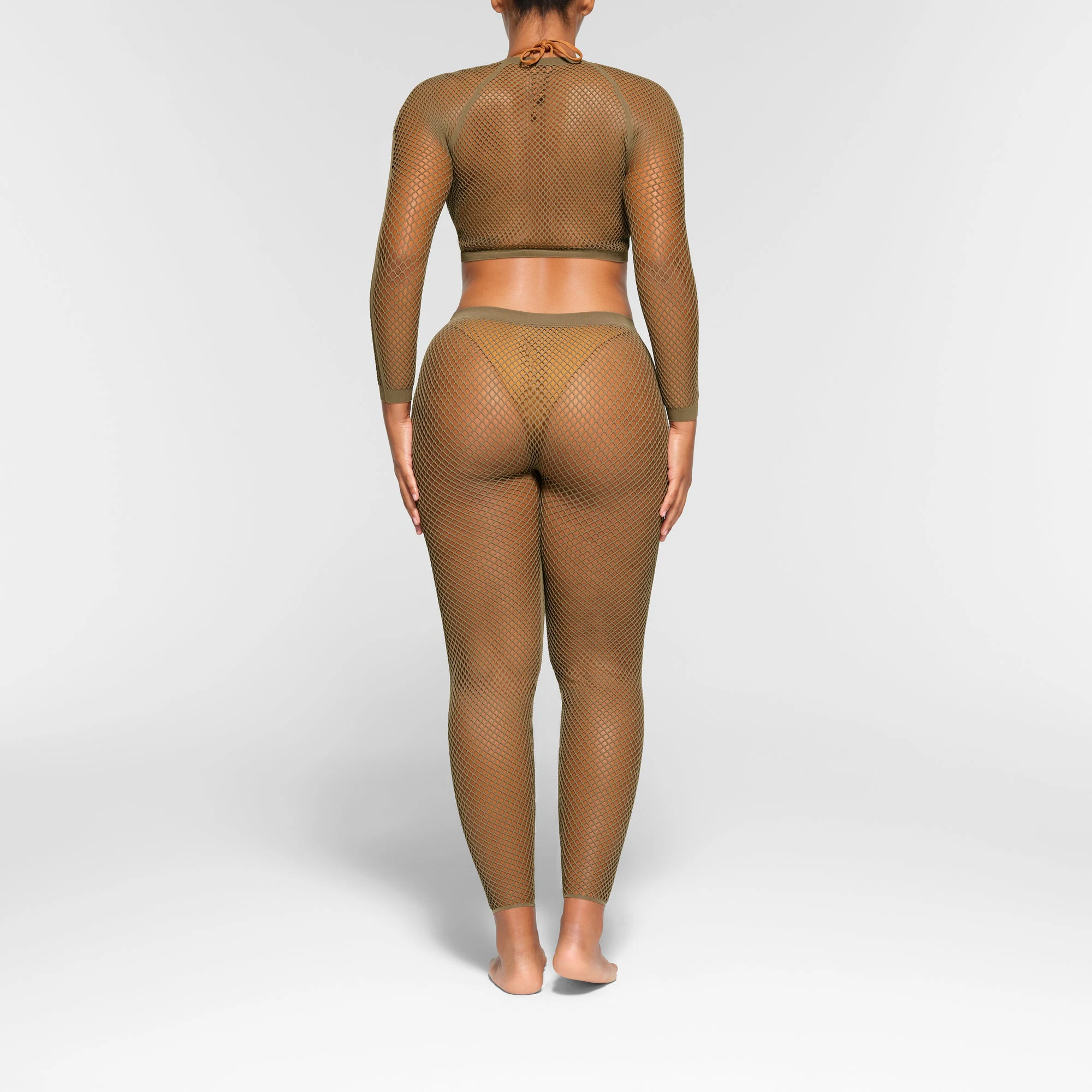 WARP KNIT COVER UP LONG SLEEVE CROPPED TOP WORN BY A MODEL IN BACK VIEW