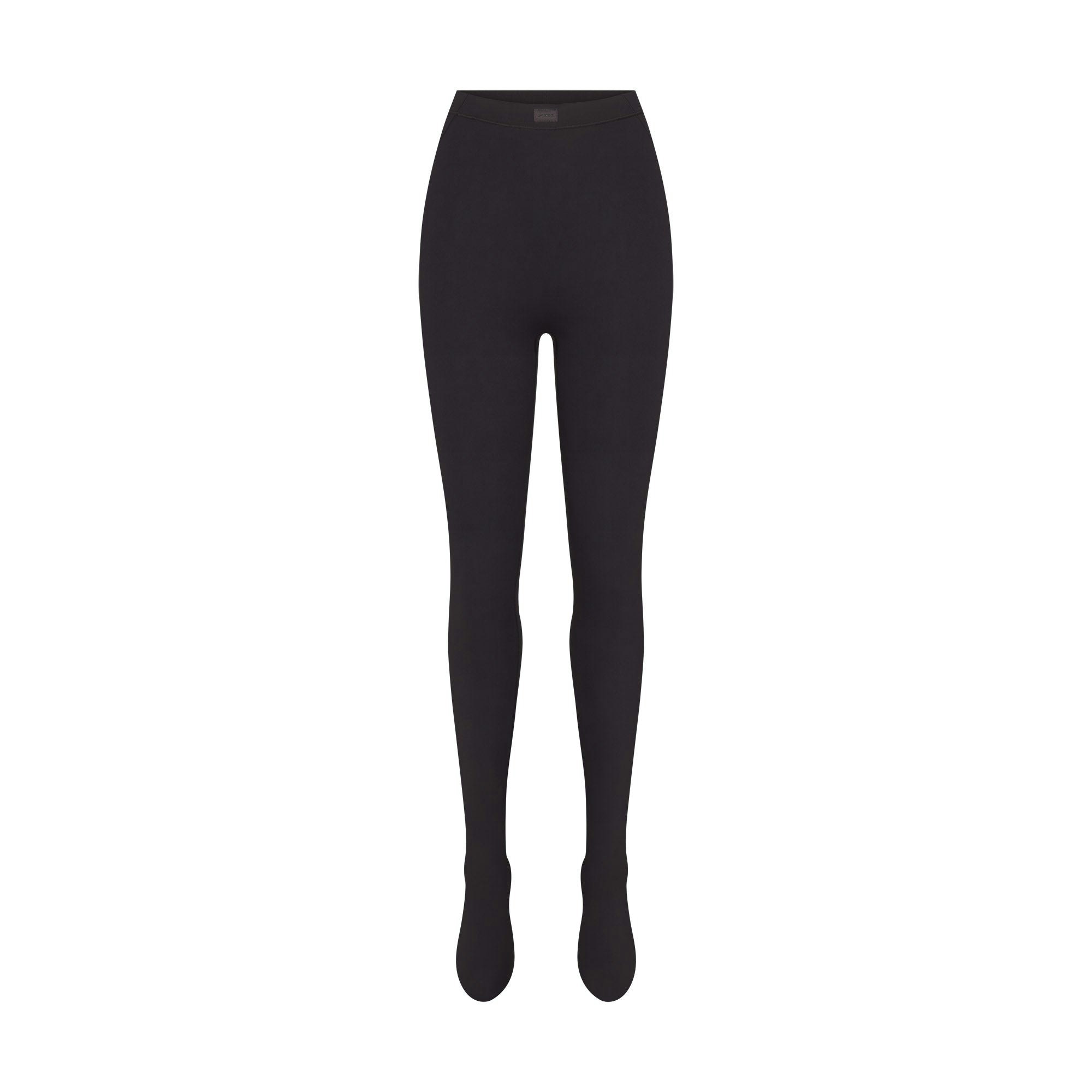 NikeSKIMS MATTE FOOTSIE GRIP LEGGING | OBSIDIAN FLAT ON A WHITE BACKGROUND | FLT