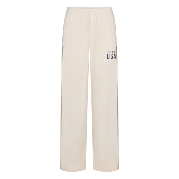 SKIMS FOR TEAM USA UNISEX FLEECE OLYMPIC SLEEP PANT | ECRUFLAT ON A WHITE BACKGROUND | FLT
