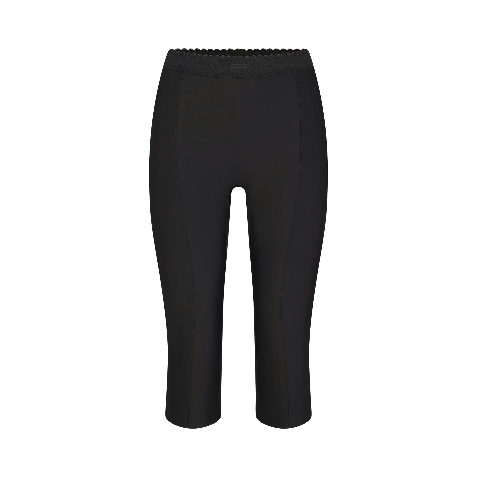 SKIMS BODY HIGH-WAISTED CAPRI | ONYX FLAT ON A WHITE BACKGROUND | FLT