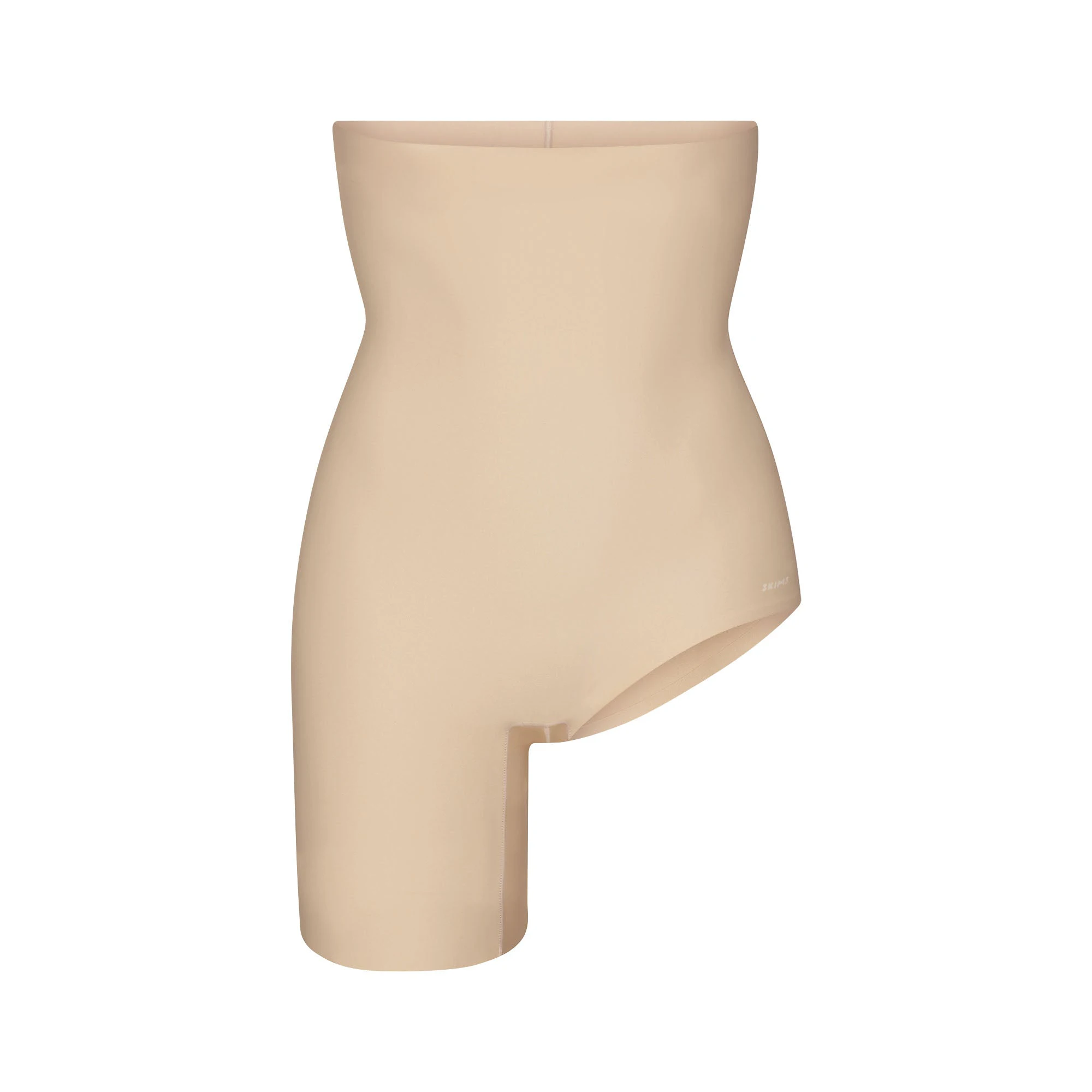 SKIMS BODY LEFT LEG SOLUTION SHORT | SAND FLAT ON A WHITE BACKGROUND | FLT