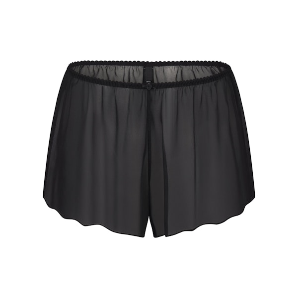 SKIMS ROMANCE SHORT LAYS FLAT ON A WHITE BACKGROUND