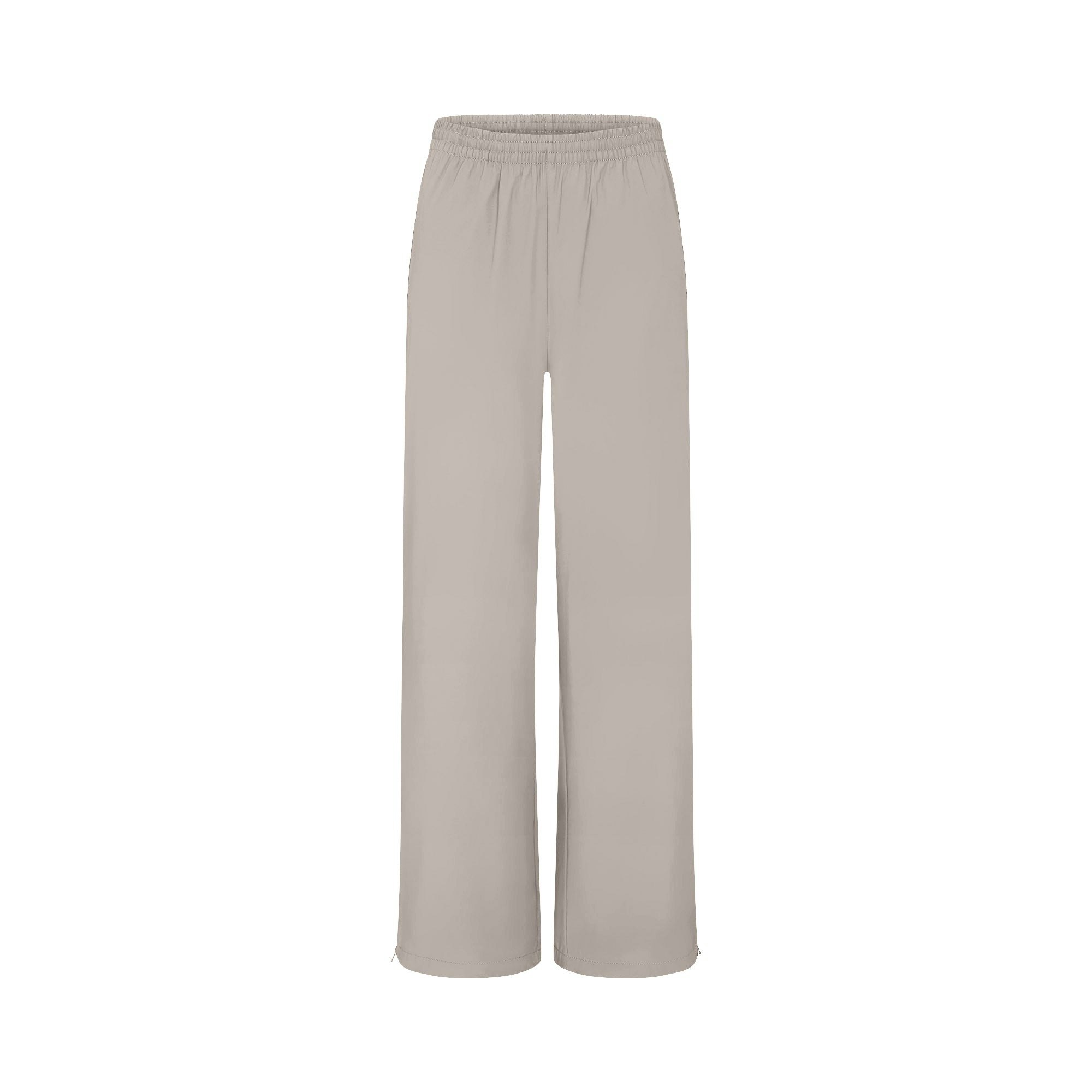 NikeSKIMS WOVEN NYLON OVERSIZED TRACK PANT | STONE FLAT ON A WHITE BACKGROUND | FLT
