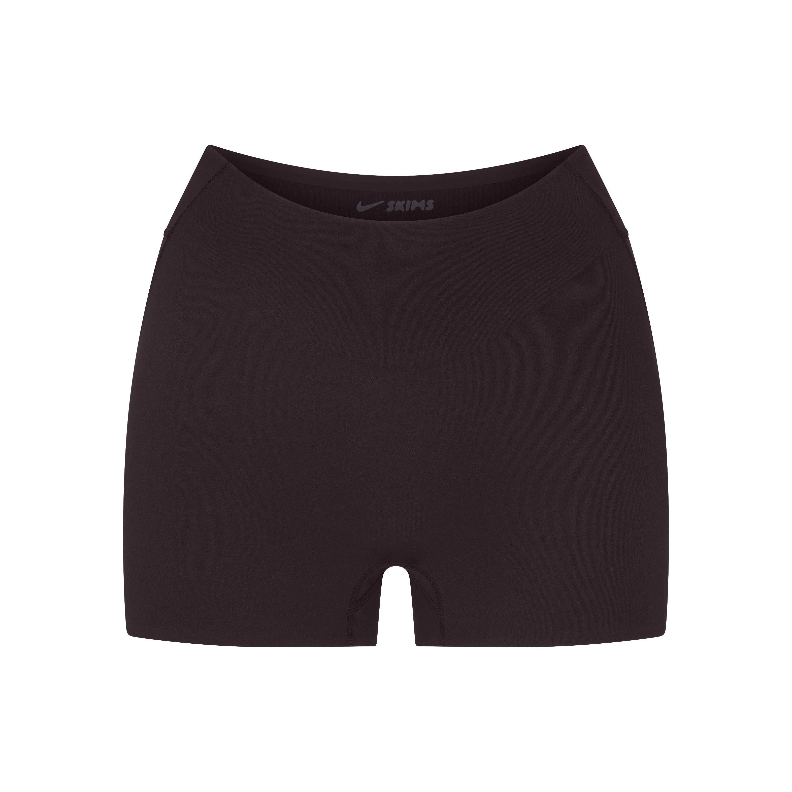 NikeSKIMS STUDIO STRETCH DIP FRONT 2" SHORT | DARK ROASTLAYS FLAT ON A WHITE BACKGROUND | FLT