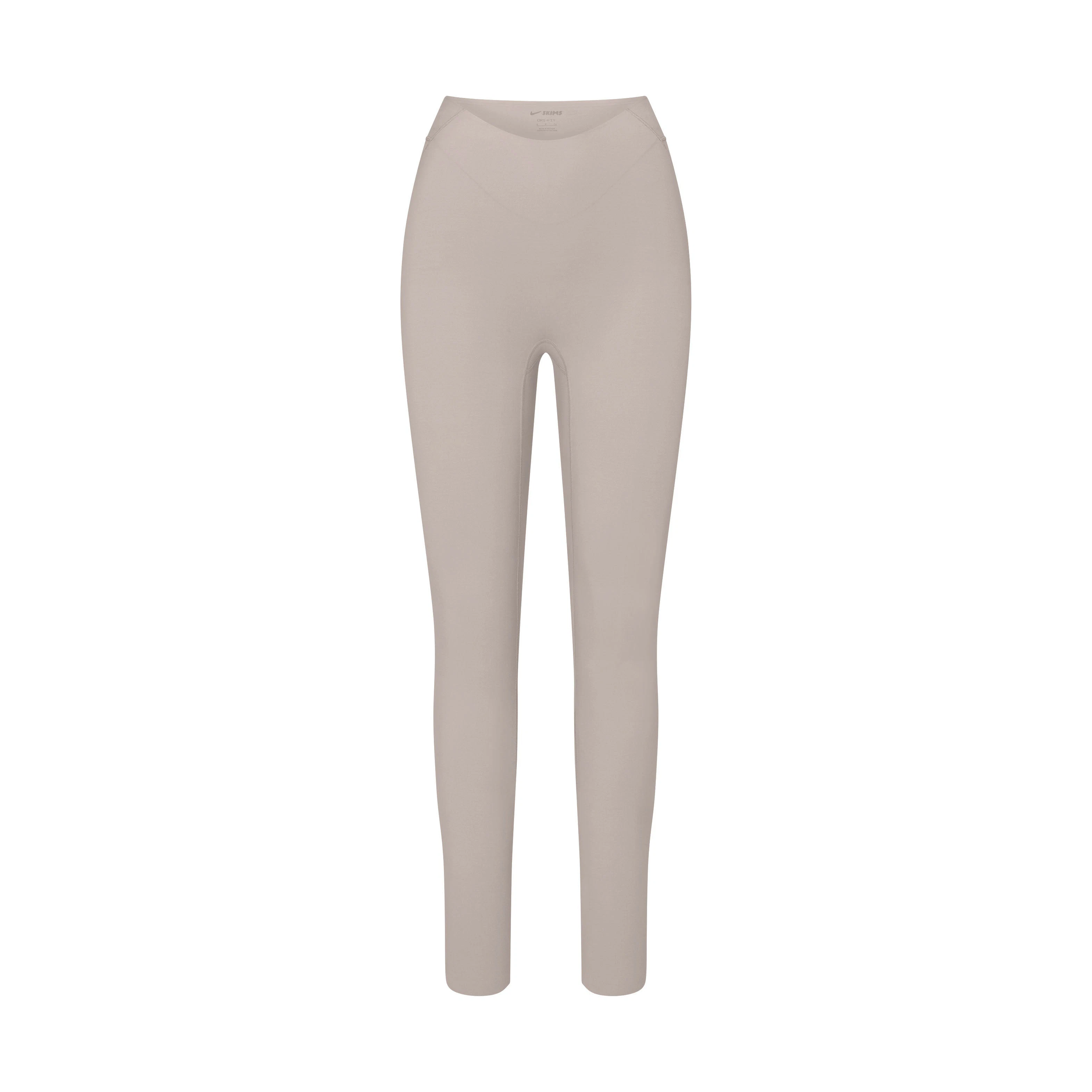 NikeSKIMS STUDIO STRETCH DIP FRONT 29" LEGGING | LINENLAYS FLAT ON A WHITE BACKGROUND | FLT