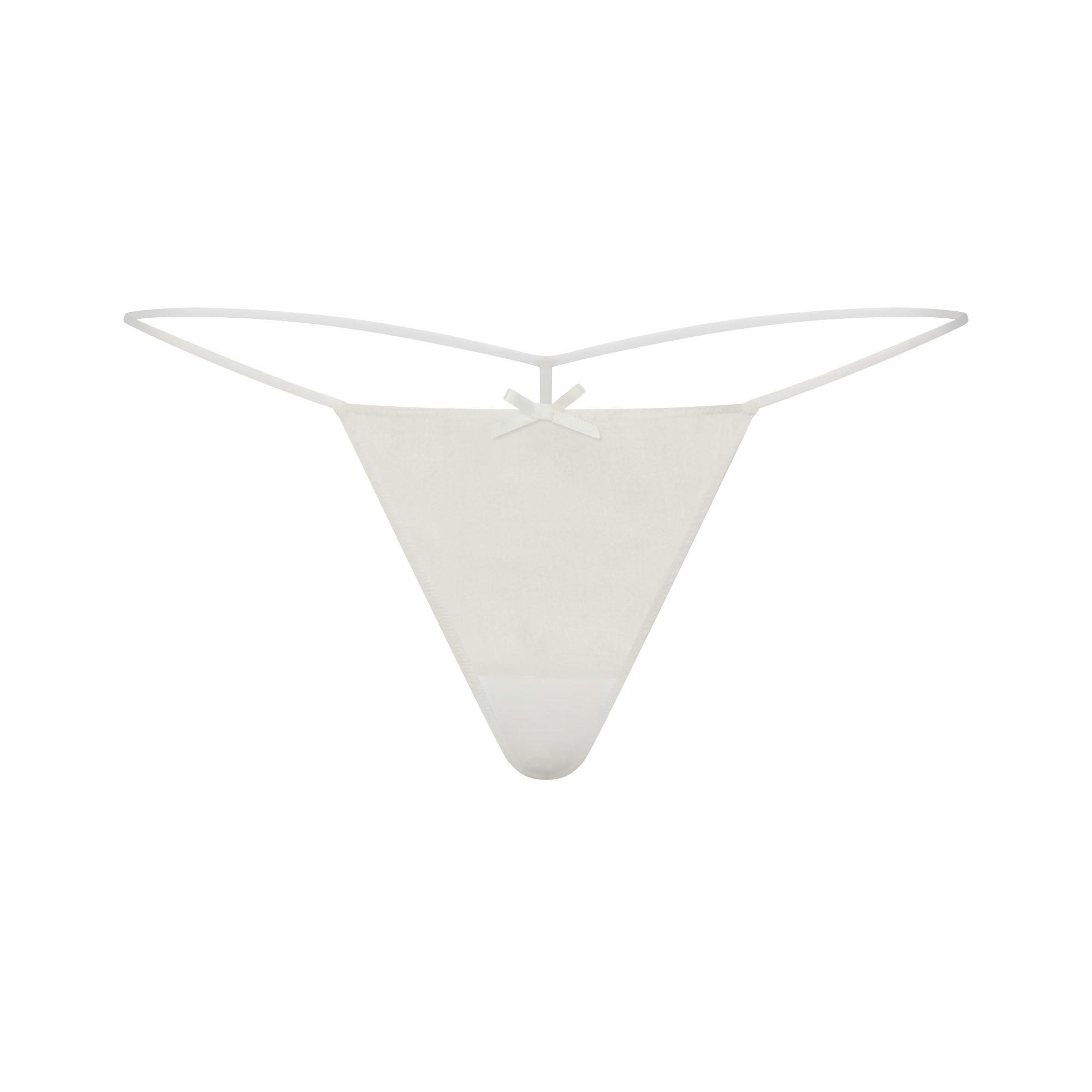 SKIMS ROMANCE BABYDOLL TOP AND STRING THONG SET | IVORY LAYS FLAT ON A WHITE BACKGROUND | FLT 