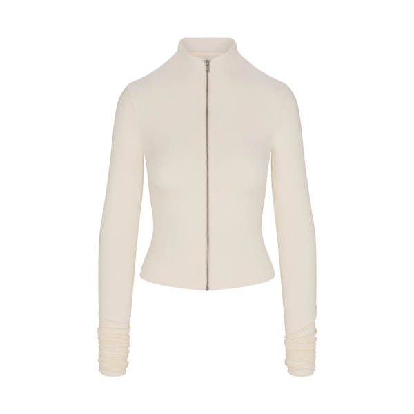 SKIMS CLOUD ZIP UP TOP | ECRU FLAT ON A WHITE BACKGROUND | FLT | FLT